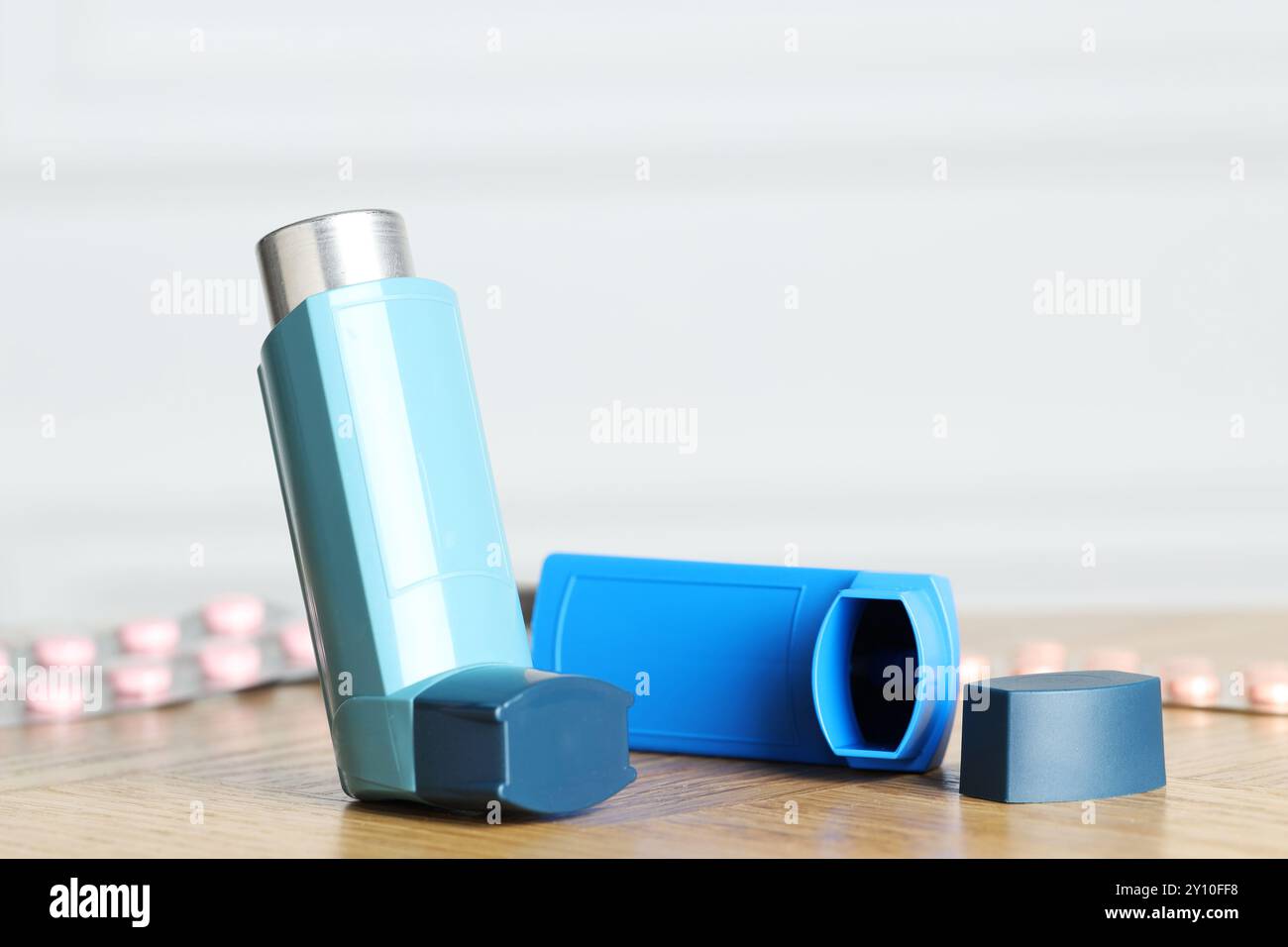 Inhalateurs sur la table en bois à l'intérieur, gros plan avec espace pour le texte. Traitement de l'asthme Banque D'Images