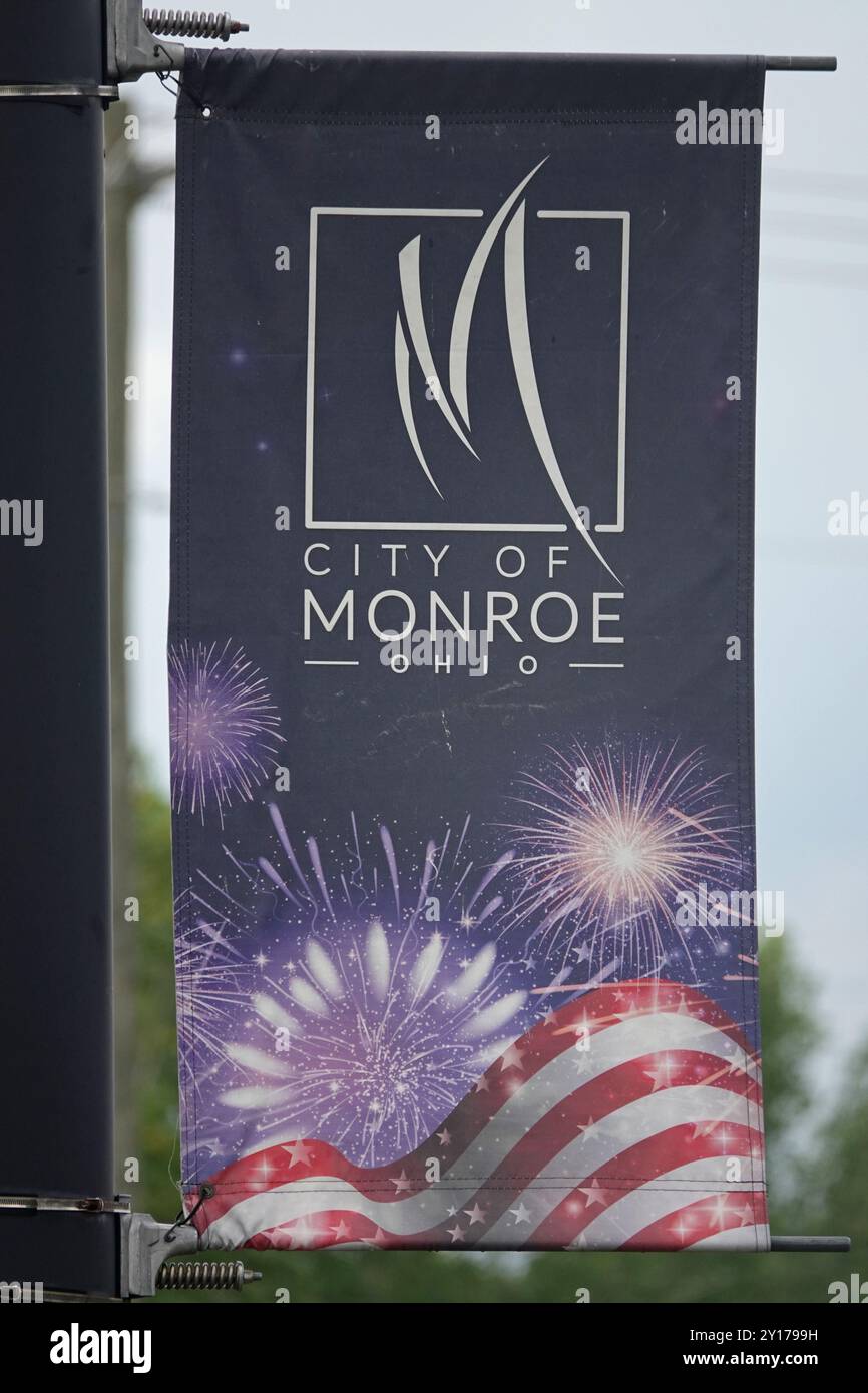 Monroe, Ohio, États-Unis - 23 juin 2024 : une bannière de la ville de Monroe, Ohio est montée sur un poteau de lampadaire pendant une journée d'été, montrant un thème patriotique de fi Banque D'Images