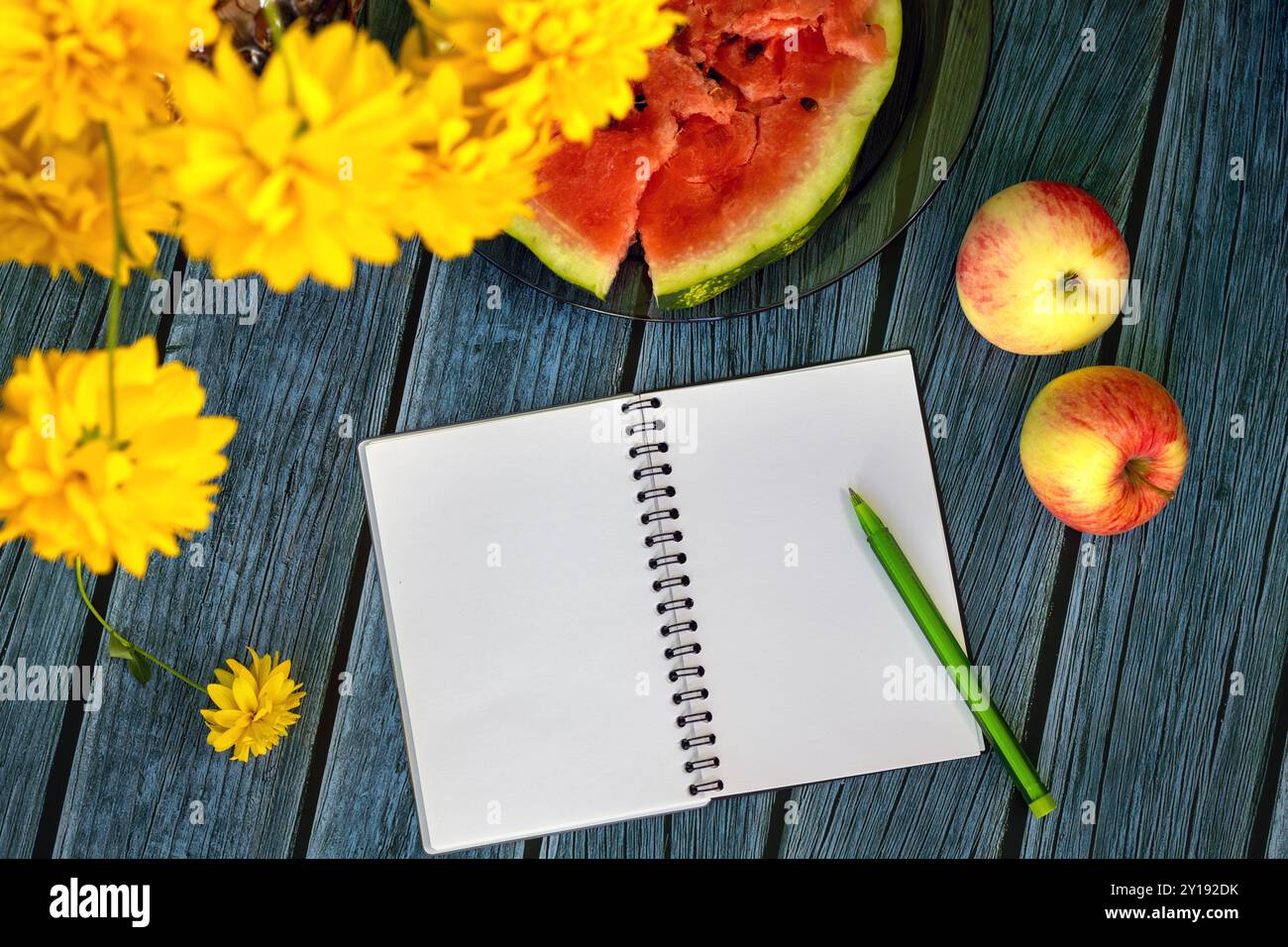 Nature morte avec des pommes, pastèque, fleurs d'automne et un cahier ouvert avec stylo pour les notes. Fin août. Vue de dessus. Banque D'Images