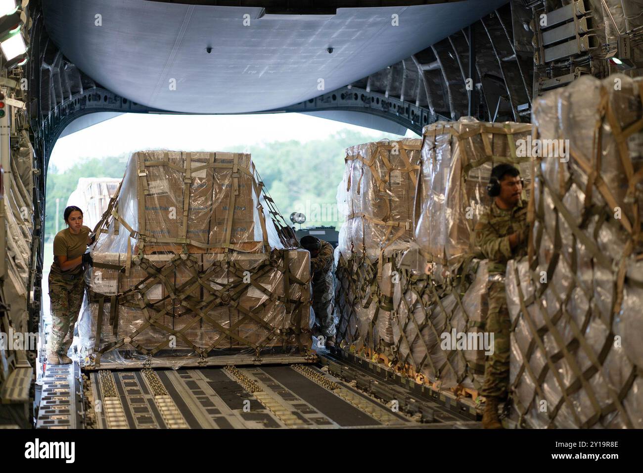 Des aviateurs américains chargent et sécurisent le fret humanitaire sur un C-17 Globemaster III Banque D'Images