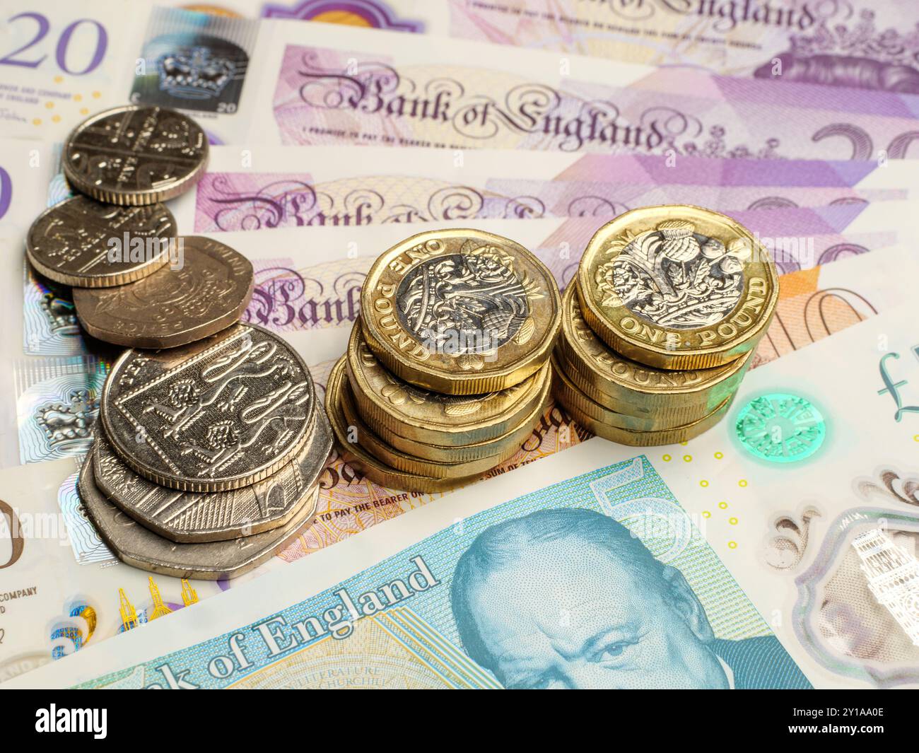 Gros plan des pièces de la livre britannique reposant sur des billets de la livre sterling argent comptant, Royaume-Uni Banque D'Images