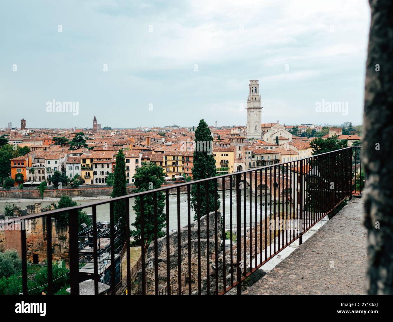 Une vue panoramique met en valeur l'architecture charmante de Vérone, avec des toits en terre cuite et un clocher saisissant sous un ciel nuageux à l'aube. Banque D'Images