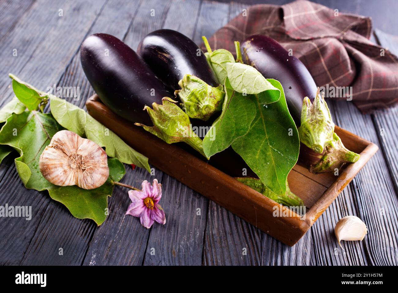 Aubergines crues ( aubergines ) dans une boîte en bois. Mise au point sélective, vue de dessus, Banque D'Images