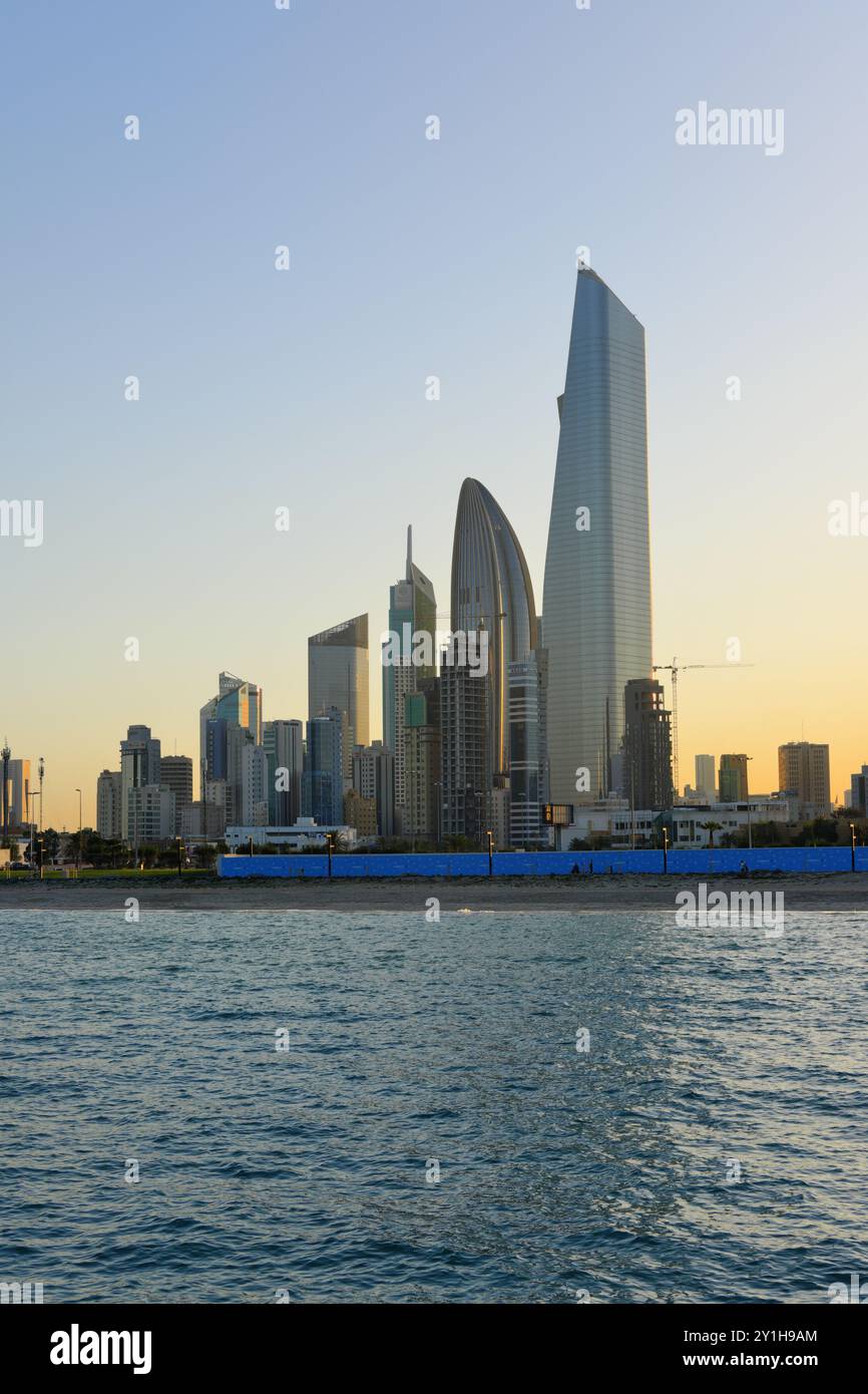 Vue de Koweït City dans une journée ensoleillée et coucher de soleil en arrière-plan. Banque D'Images