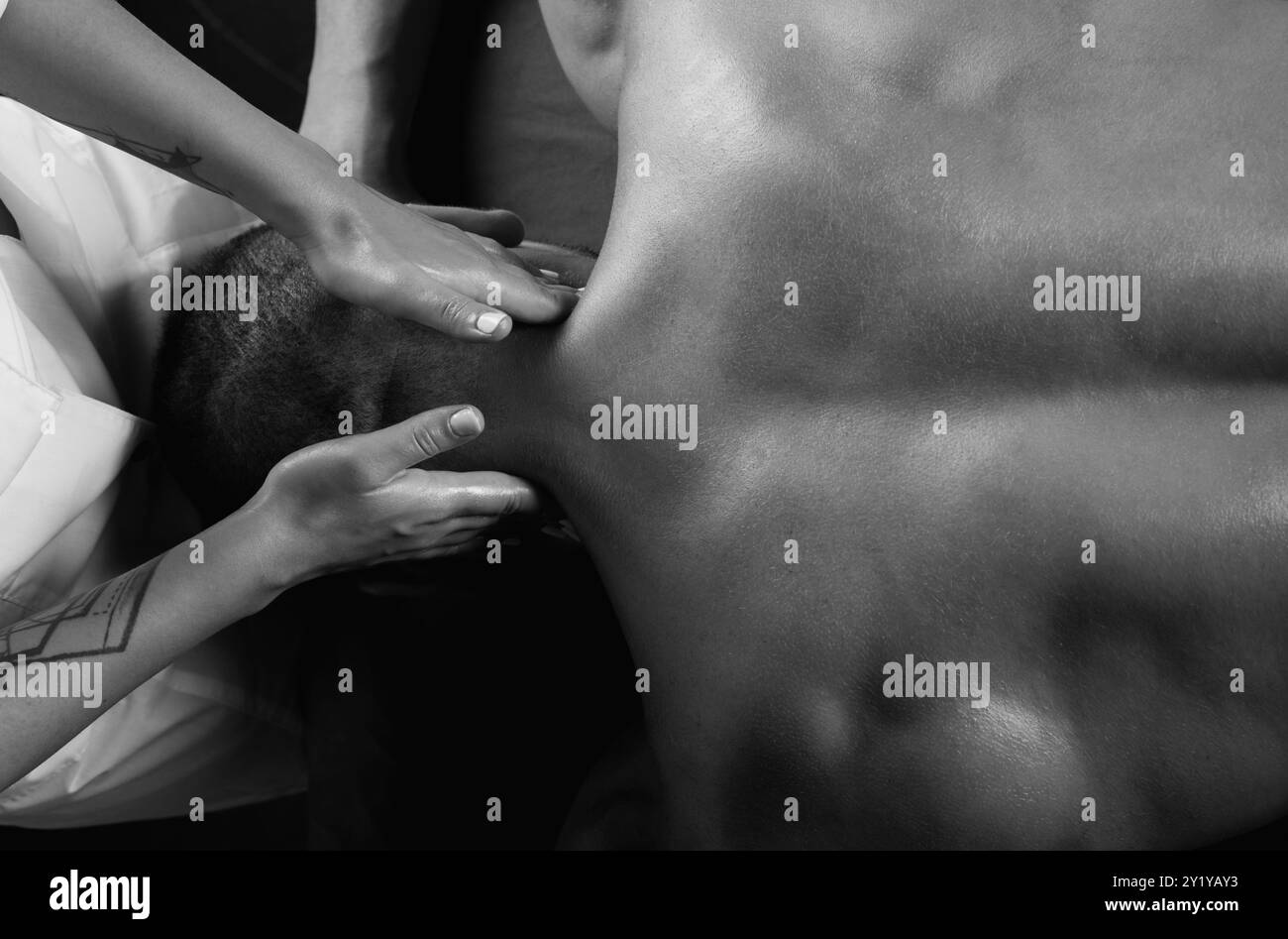 Masser l'épaule musculaire, gros plan. Massage pour homme gros plan. Physiothérapeute massant le cou masculin. Homme se détendant sur la table de massage recevant un massage. Banque D'Images