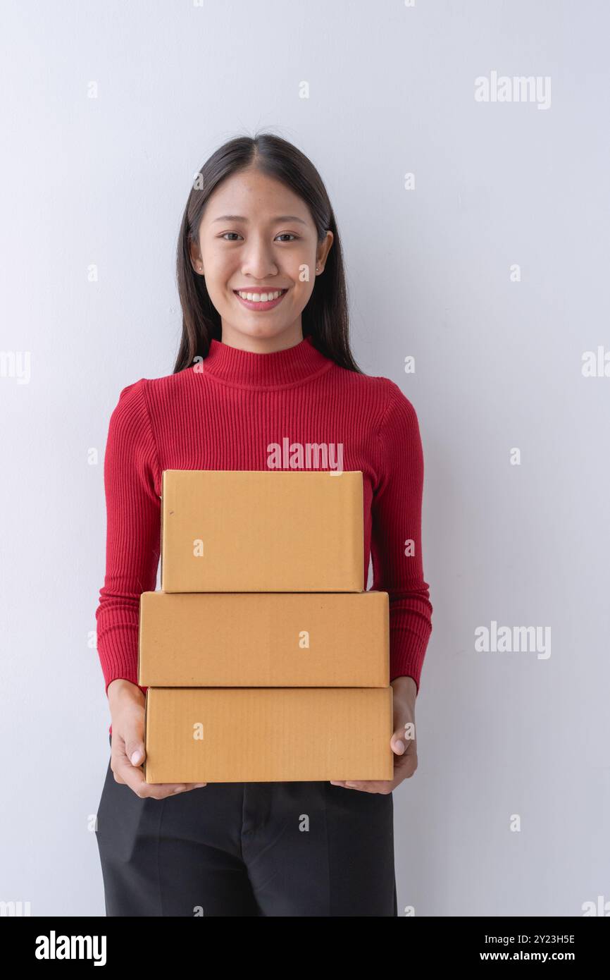 femme, vendeuse en ligne, gère efficacement les commandes des clients et la livraison via la plateforme e-commerce. Banque D'Images