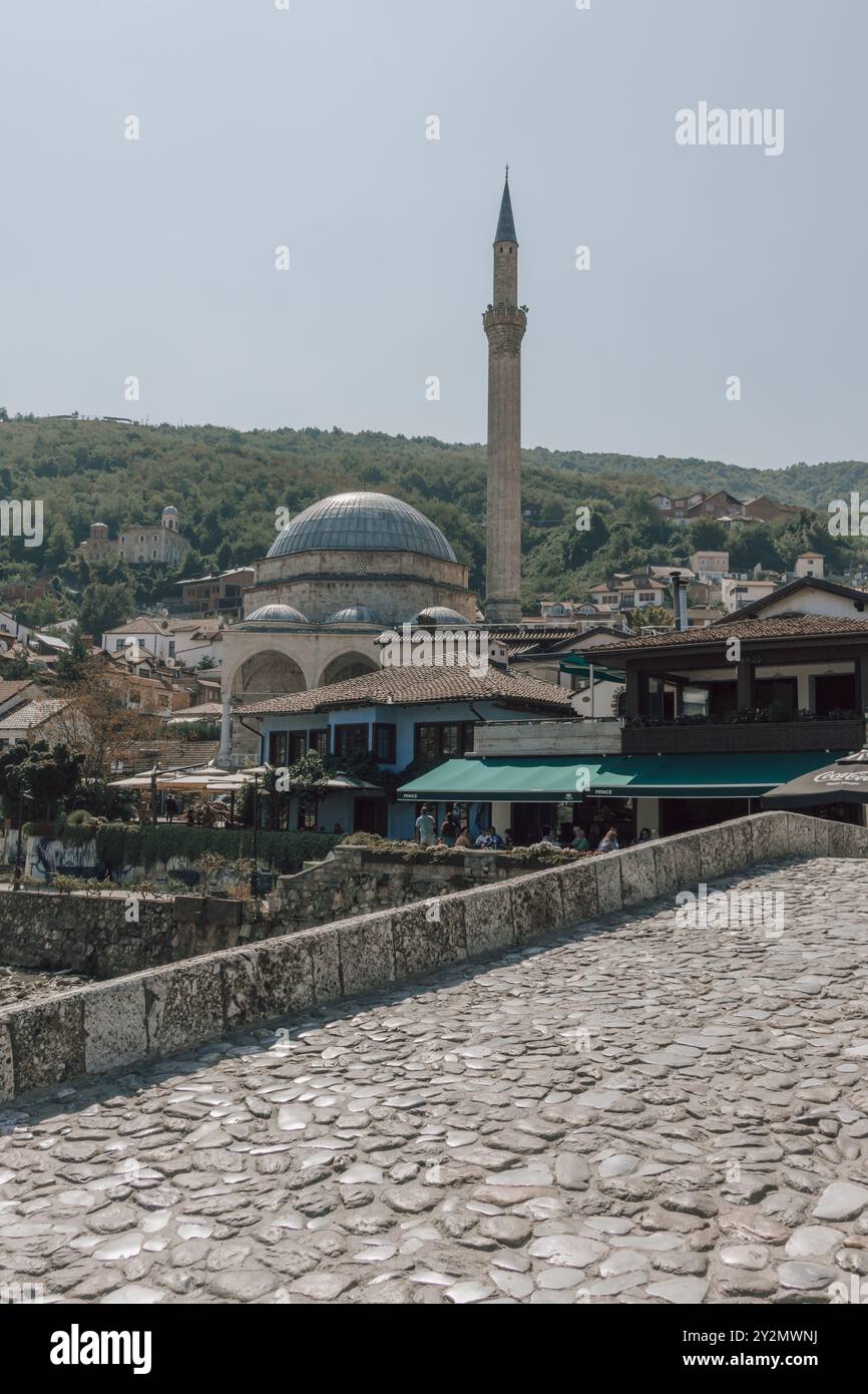 Une vue du célèbre minaret de la mosquée Sinan Pacha dans la vieille ville historique de Prizren au Kosovo dans les Balkans. Vue depuis le vieux pont de pierre. Banque D'Images