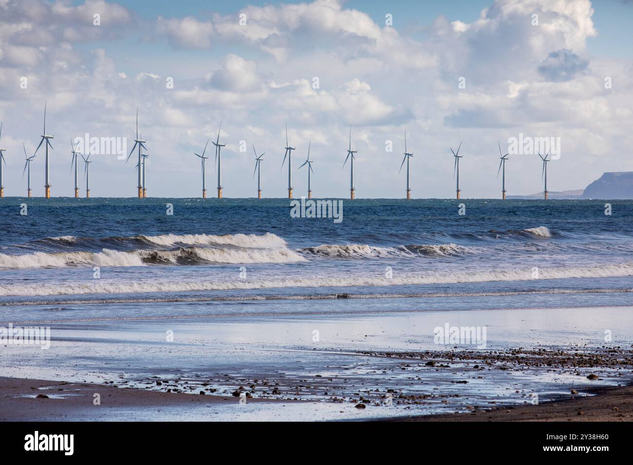 Un parc éolien offshore au large de la côte de Seaton Carew , Hartlepool, Teeside, Royaume-Uni comme un pétrolier passe devant les éoliennes et les vagues balaient sur la côte et la côte du nord-est de l'Angleterre. Banque D'Images