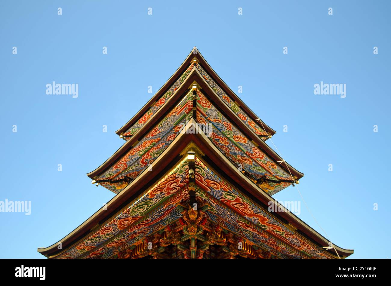 Temple Naritasan Shinshoji trois chevrons de la pagode à trois étages Narita Japon // NARITA, Japon — les chevrons richement peints de la pagode à trois étages du temple Naritasan Shinshoji affichent des couleurs vives et des motifs complexes caractéristiques de l'architecture bouddhiste japonaise traditionnelle. La pagode de 25 mètres de haut a été construite à l'origine en 1712 et représente l'une des structures les plus importantes du temple. Le temple Naritasan Shinshoji, fondé en 940, est dédié à Fudo Myoo et sert de temple principal à la branche Chisan de la secte bouddhiste Shingon. Le complexe du temple attire des millions de visiteurs ann Banque D'Images