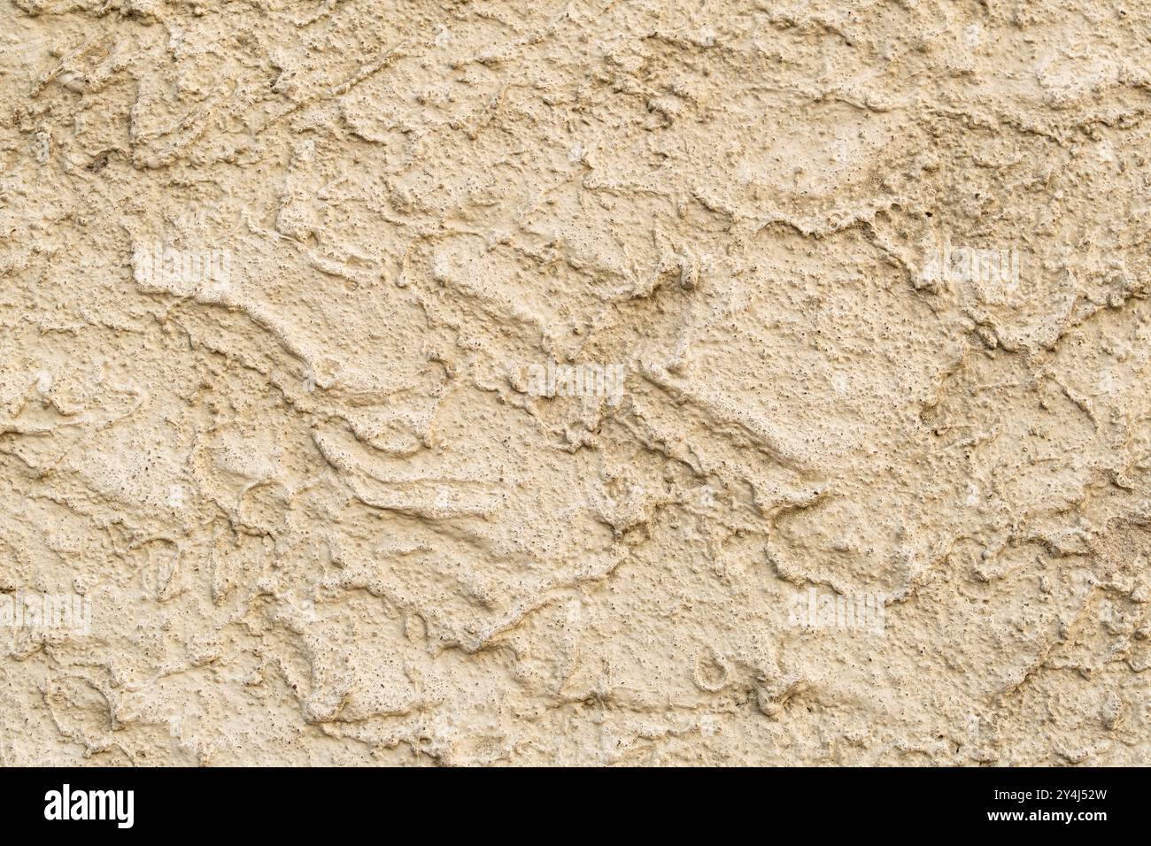 Plâtre jaune sur le mur de style brut, texture sablonneuse, utilisé comme finition de façade extérieure. texture des matériaux de construction Banque D'Images