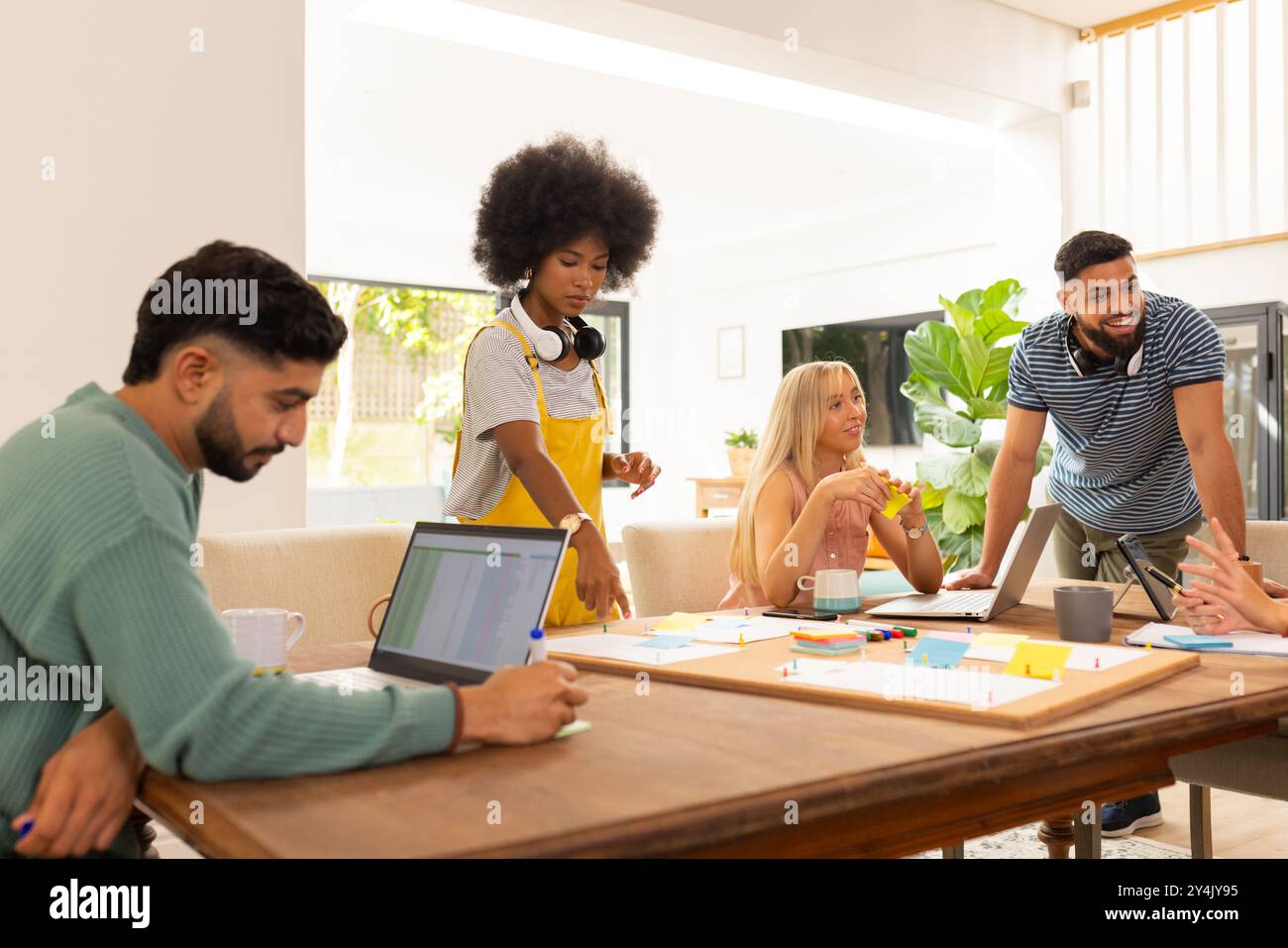 Démarrer une entreprise, collaborer sur un projet, groupe diversifié d'amis utilisant des ordinateurs portables et des notes autocollantes Banque D'Images