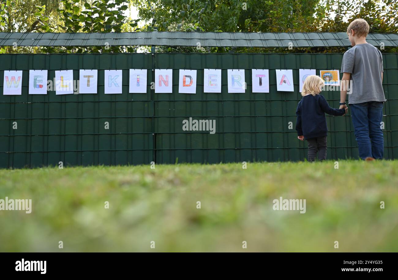 19 septembre 2024, basse-Saxe, Leer : un garçon et une fille regardent le lettrage de la Journée mondiale de l'enfance sur le devant d'un jardin d'enfants en Frise orientale. De 0830 déclarations avec la ministre fédérale Lisa Paus (Verts), membre du conseil d'administration du Fonds allemand pour l'enfance, Anja Siegesmund et membre du conseil d'administration de l'UNICEF Allemagne, Daniela Schadt (place devant la maison Paul Löbe, entrée ouest) la journée est célébrée à différentes dates dans le monde entier. L'ONU célèbre la Journée mondiale de l'enfance le 20 novembre. En Allemagne, elle est célébrée le 20 septembre depuis 1954. De nombreuses villes dans les nouveaux états fédérés célèbrent Banque D'Images