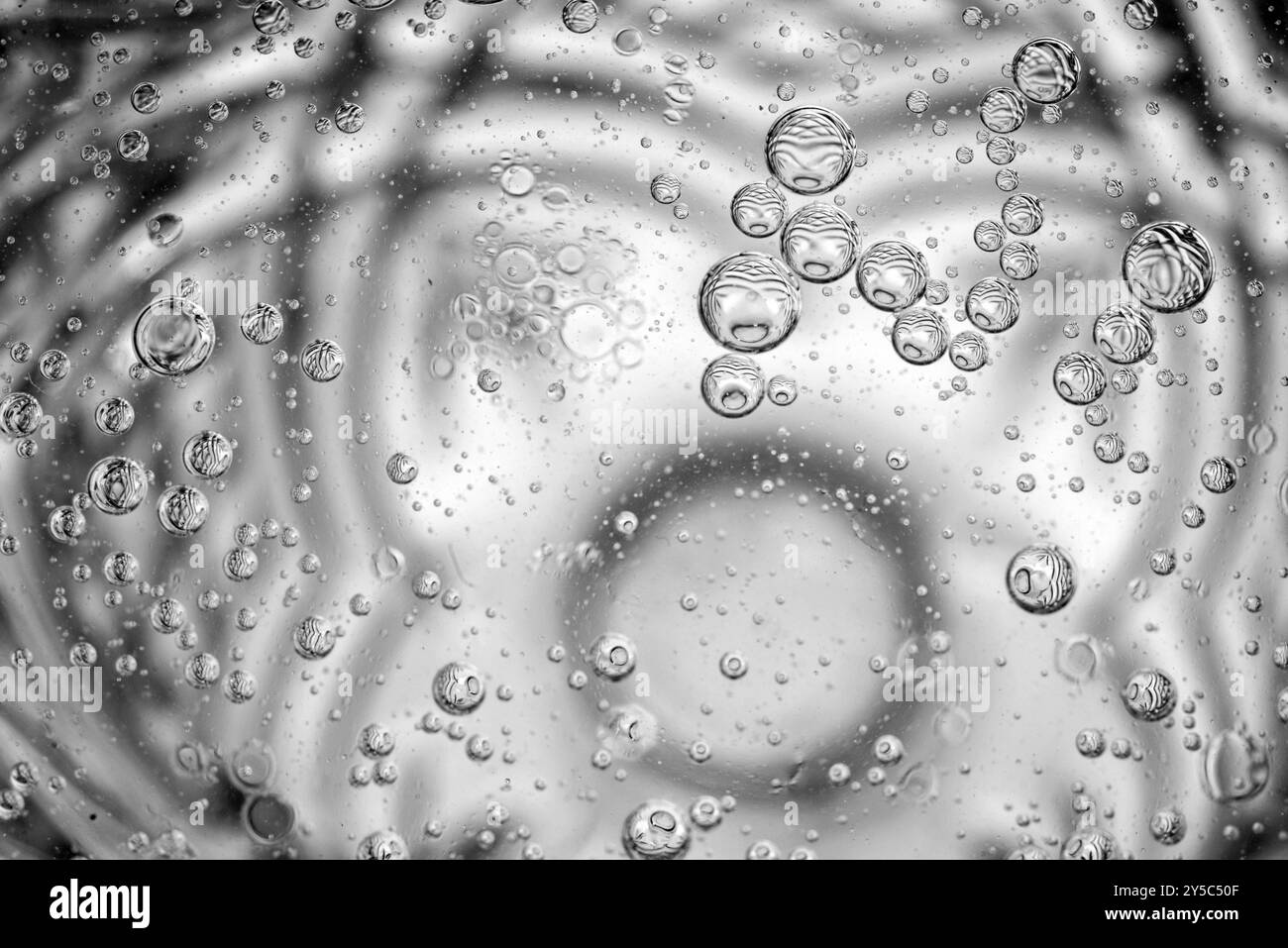 L'huile tombe dans un verre d'eau Banque D'Images