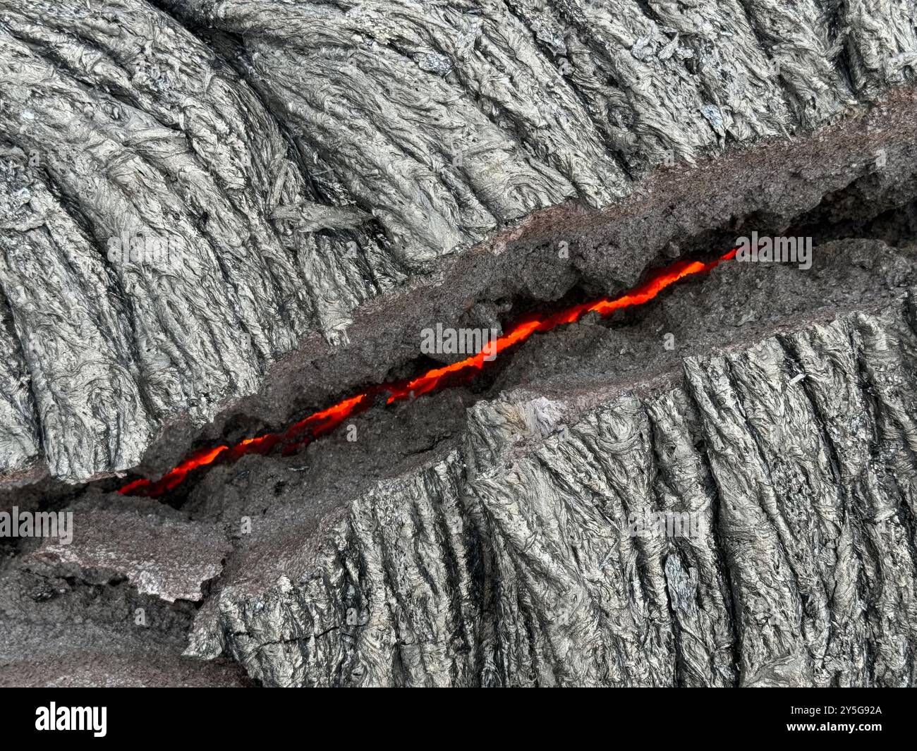 Kilauea (États-Unis d'Amérique). 20 septembre 2024. Kilauea (États-Unis d'Amérique). 20 septembre 2024. Une fissure incandescente dans de la lave fraîche sur le plancher du cratère Napau à l’intérieur du volcan Kilauea causée par la récente éruption de la zone East Rift au parc national des volcans d’Hawaï, le 20 septembre 2024 à Hawaï. Pahoehoe se caractérise par des textures de surface lisses, bouffantes et ondulées. Credit : Matthew Patrick/USGS/Alamy Live News Banque D'Images