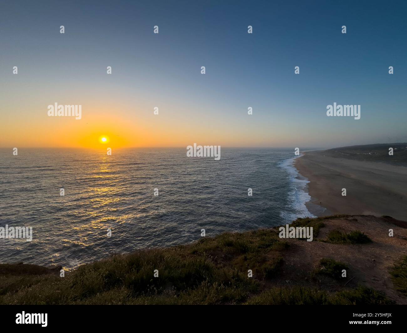 Vue panoramique de la plage du Nord (Praia do Norte) au coucher du soleil, à Nazare, Portugal Banque D'Images