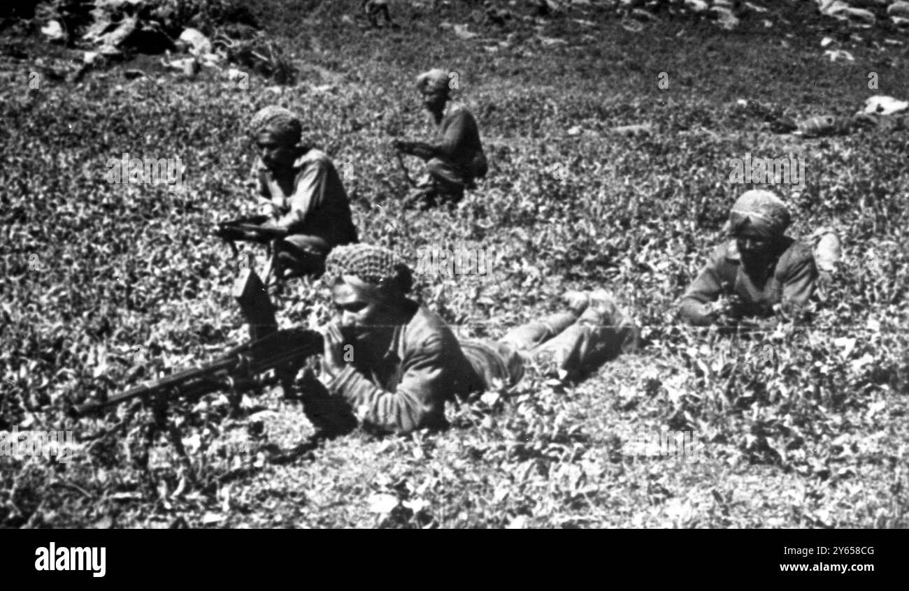 Les troupes indiennes sont photographiées avançant récemment à travers les broussailles des montagnes au Cachemire pour capturer le col de la colline de Haji Pir . Le premier ministre indien, M. Lal Bahadur Shastri, a déclaré que l'important laissez-passer est toujours entre les mains des Indiens. Hier , le Pakistan a envoyé de l'infanterie et des chars à travers la ligne de cessez-le-feu du Cachemire pour la première fois en 17 ans . Selon un porte-parole , des avions pakistanais ont abattu quatre avions indiens . 2 septembre 1965 Banque D'Images