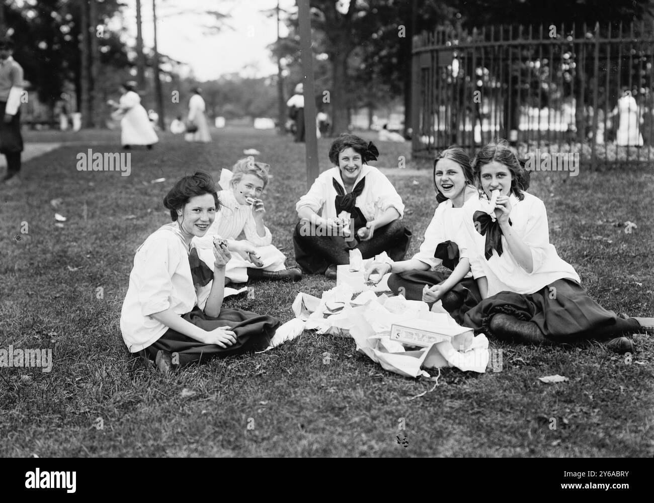 Midsummer Day, Bronx Park, photographie montre des filles des Washington Irving High Schools, New York City, en train de pique-niquer au MidSummer Day Festival qui a eu lieu au Pelham Bay Park dans le Bronx le 23 juin 1911., 1911 juin 23, enfants, verres négatifs, 1 négatif : verre ; ou plus petit. Banque D'Images