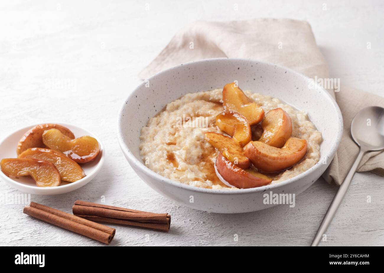 Bouillie d'avoine sucrée avec tranches de pommes cuites au four, cannelle et sauce caramel Banque D'Images
