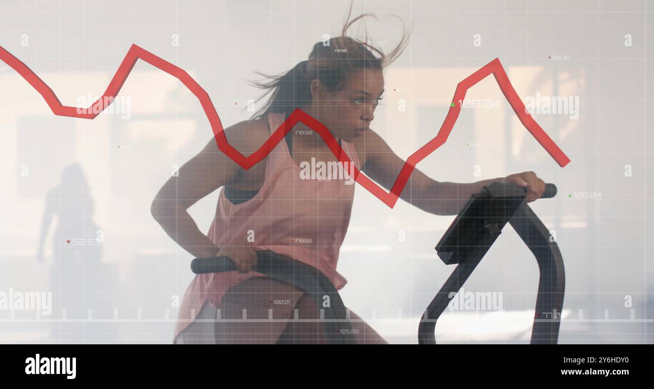 Exercice sur le vélo stationnaire, femme avec l'image graphique du marché boursier sur Banque D'Images