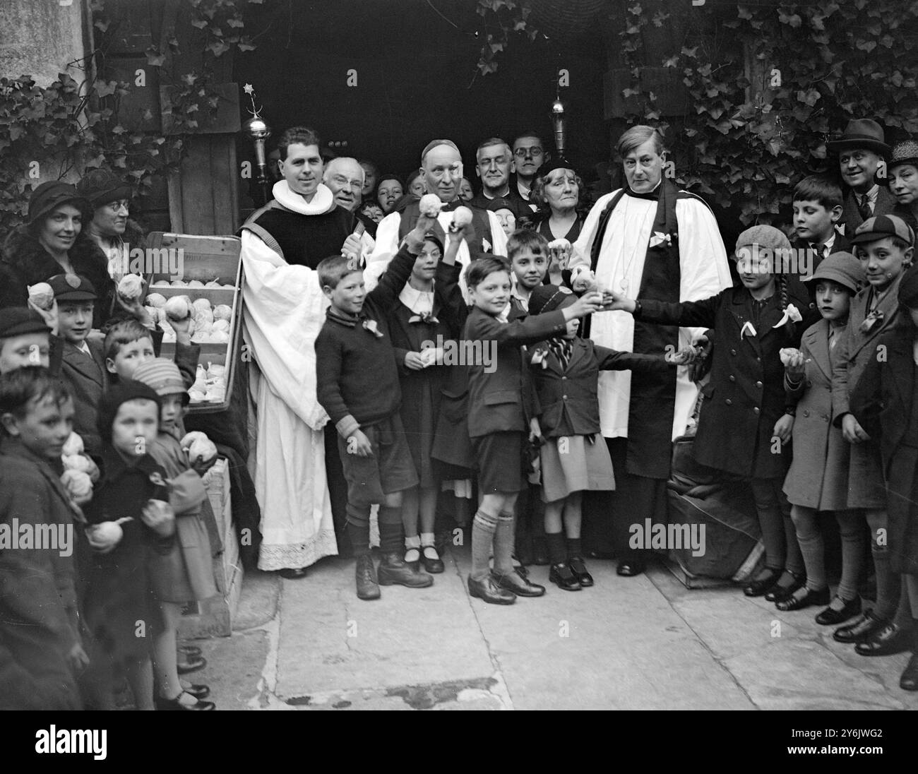 Le révérend W Pennington Bickford avec de petits paroissiens au service annuel des oranges et des citrons à l'église St Clement Danes de Londres. 31 mars 1933 Banque D'Images