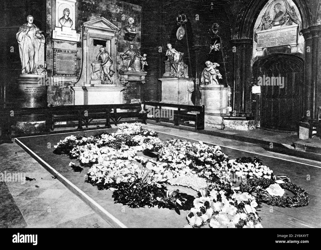 Repos parmi ses pairs à l'abbaye de Westminster : la couronne couvrait Dais au-dessus du sol dans le coin des poètes , où les cendres de Thomas Hardy ont été déposées à côté de la tombe de Dickens - Une vue après la cérémonie funéraire montrant des mémoriaux à Shakespeare ( la statue centrale à gauche , Burns ( à droite ) , Goldsmith ( au-dessus de la porte ) et Scott ( le buste à droite de la porte ) . 21 janvier 1928 Banque D'Images