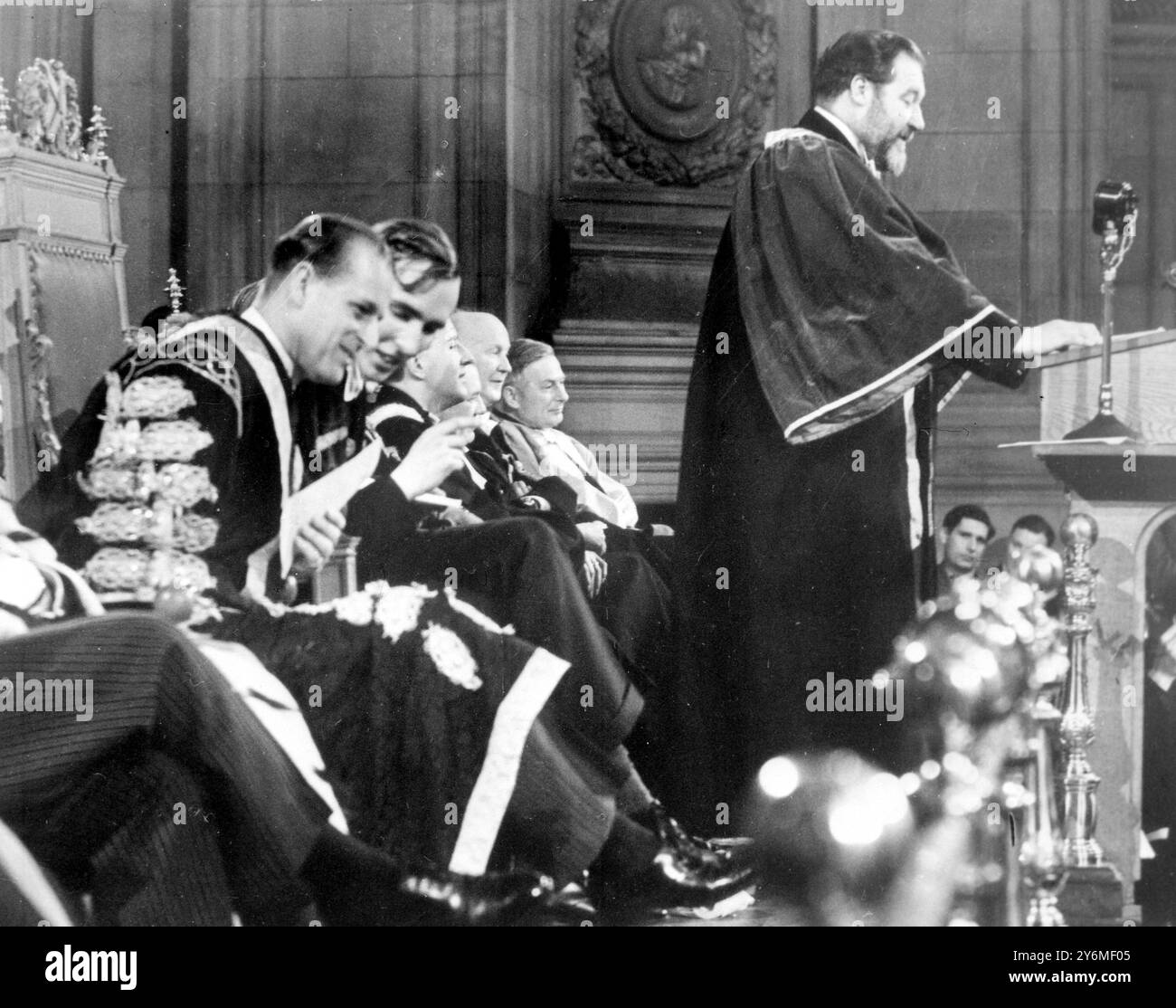 Édimbourg : alors que le nouveau recteur de l'Université d'Édimbourg, James Robertson Justice le film et l'acteur, font son discours aux étudiants emballés dans McEwan's Hall, Prince Philip écoute un amusant en dehors de M. Patrick Hamilton, président du conseil représentatif des étudiants. La cérémonie était habituellement trépidante, et les tomates, la farine et l'eau ont accueilli tous les dignitaires à leur arrivée pour la cérémonie d'installation. 20 février 1958 Banque D'Images