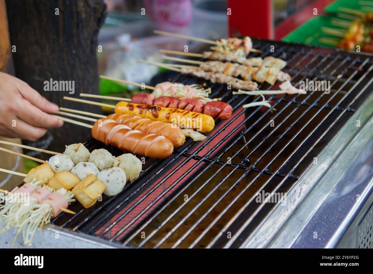 Gros plan de saucisse et boulette de viande grillées à la main sur le gril barbecue Banque D'Images