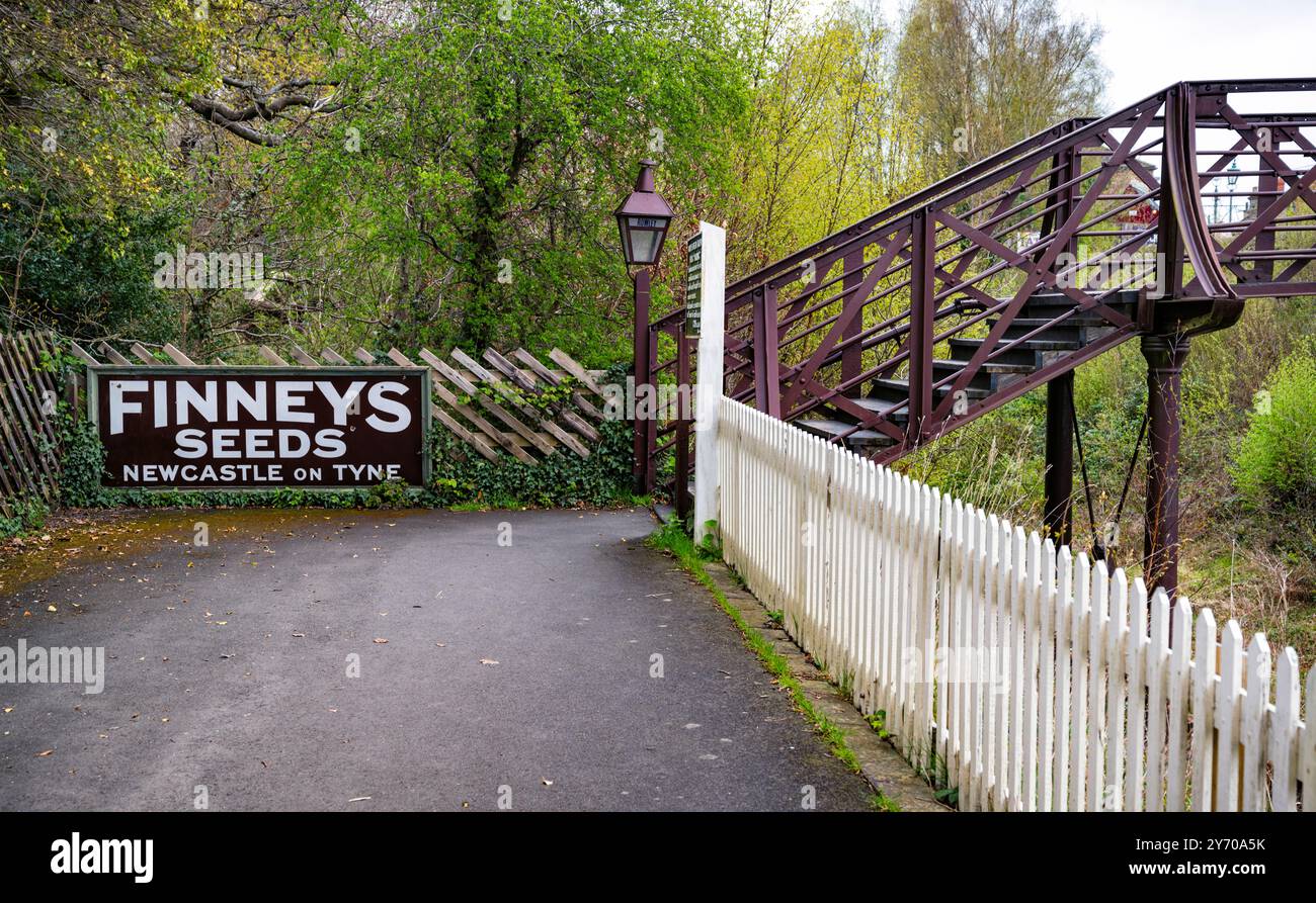 Passerelle ferroviaire et panneau publicitaire vintage à Rowley Station, Beamish Museum, comté de Durham, Angleterre, Royaume-Uni. Banque D'Images