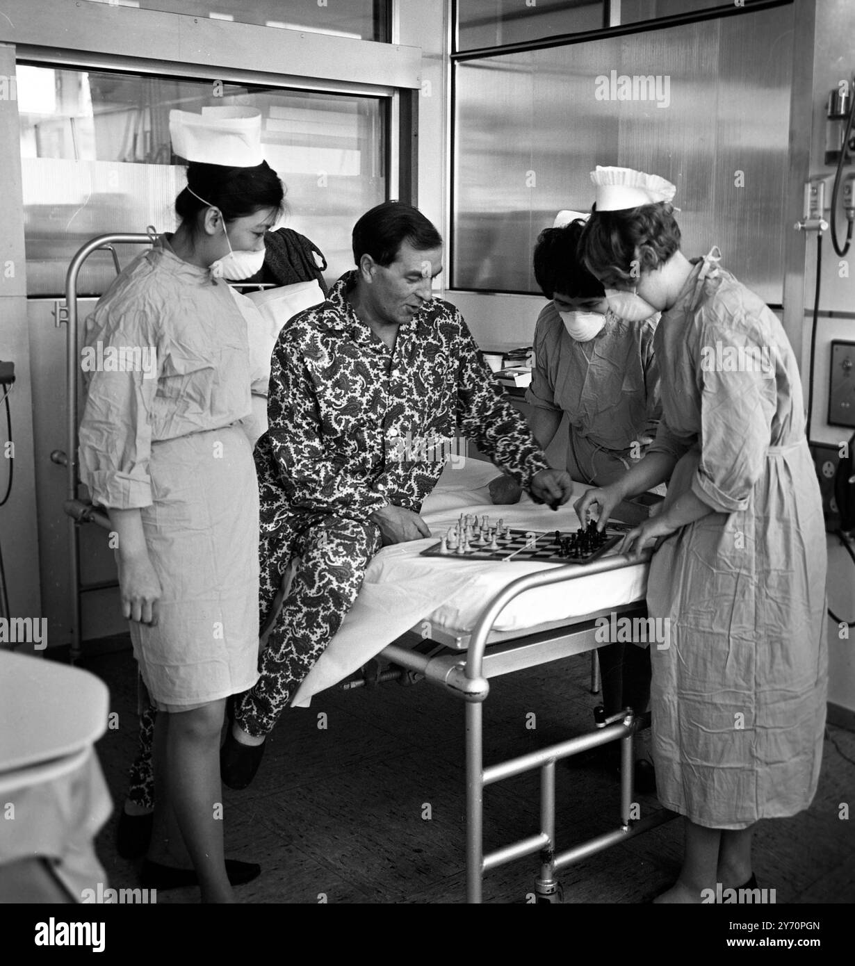 M. Frederick West 45 , de Leigh-on-Sea , premier patient de transplantation cardiaque britannique , au National Heart Hospital , Marylebone , Londres , profite aujourd'hui d'une partie d'échecs avec ses infirmières dans sa suite spéciale . Hier , M. West a été déplacé du théâtre où l'opération a eu lieu il y a trois semaines et trois jours , dans sa propre suite d'hôpital . M. West a reçu le coeur du charpentier Irlandais , M. Patrick Ryan , 26 ans , décédé suite à une chute d'un chantier de construction . 28 mai 1968 Banque D'Images