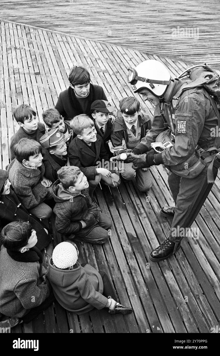 SKYMAN TOMBE EN ............ BRIGHTON ; Un groupe d'écoliers attentifs regardent le caporal Brian David de la célèbre équipe de parachutisme en chute libre des 'Red Devils' du Parachute Regiment, démontrer les astuces de son commerce avec un jouet d'action Man Red Devil. C'est la dernière ligne de poupée pour garçons fantastiquement réussie, qui peut être obtenue avec une série de tenues et d'uniformes authentiques. Il s'est rendu à Brighton pour expliquer l'équipement avec la poupée aux jeunes qui assistent à l'ouverture de la foire du jouet de Brighton aujourd'hui. 28 janvier 1968 Banque D'Images