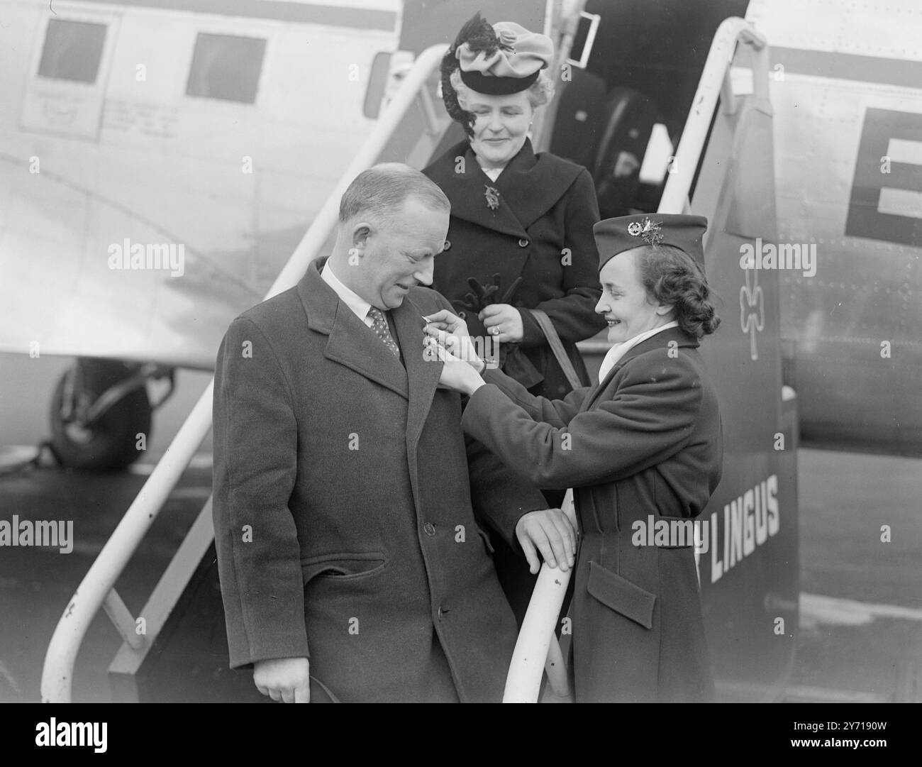 ST. PATRICK DANS L'AIR DR . DONAL CURRAN de Dublin est assuré d'un vrai St. Vol Patrick's Day pour Eire . Juste avant de quitter l'aéroport Northolt , Middlesex , par Aer Lingus , la ligne aérienne irlandaise , Hostess MAUREEN O' NEILL , également de Dublin , lui présente des trèfles . Tous les passagers à Eire ont reçu Shamrock aujourd'hui. 17 mars 1949 Banque D'Images