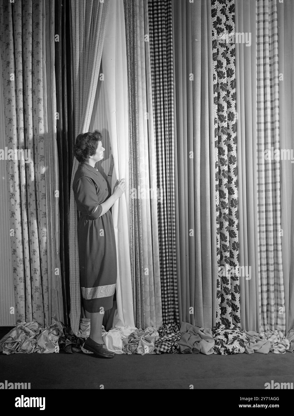 L'INDUSTRIE BRITANNIQUE DE LA RAYONNE EST '' VITRINE MONDIALE '' Une vitrine mondiale pour l'industrie britannique de la rayonne a vu le jour officiellement lorsque M. Harold Wilson, président de la Chambre de commerce , a ouvert le rayon Industry Design Centre à Upper Grosvenor Street , Londres . Sur l'affichage sont les derniers développements dans l'industrie pour l'inspection des acheteurs d'outre-mer. Les femmes britanniques accueilleront également le défilé du rayon. Il est tellement plus fort que d'autres matériaux ainsi que moins cher. L'IMAGE MONTRE:- Miss . MARY ADAMS , de Bristol , exposant quelques-unes des nombreuses variétés de tissus au rayon I. Banque D'Images
