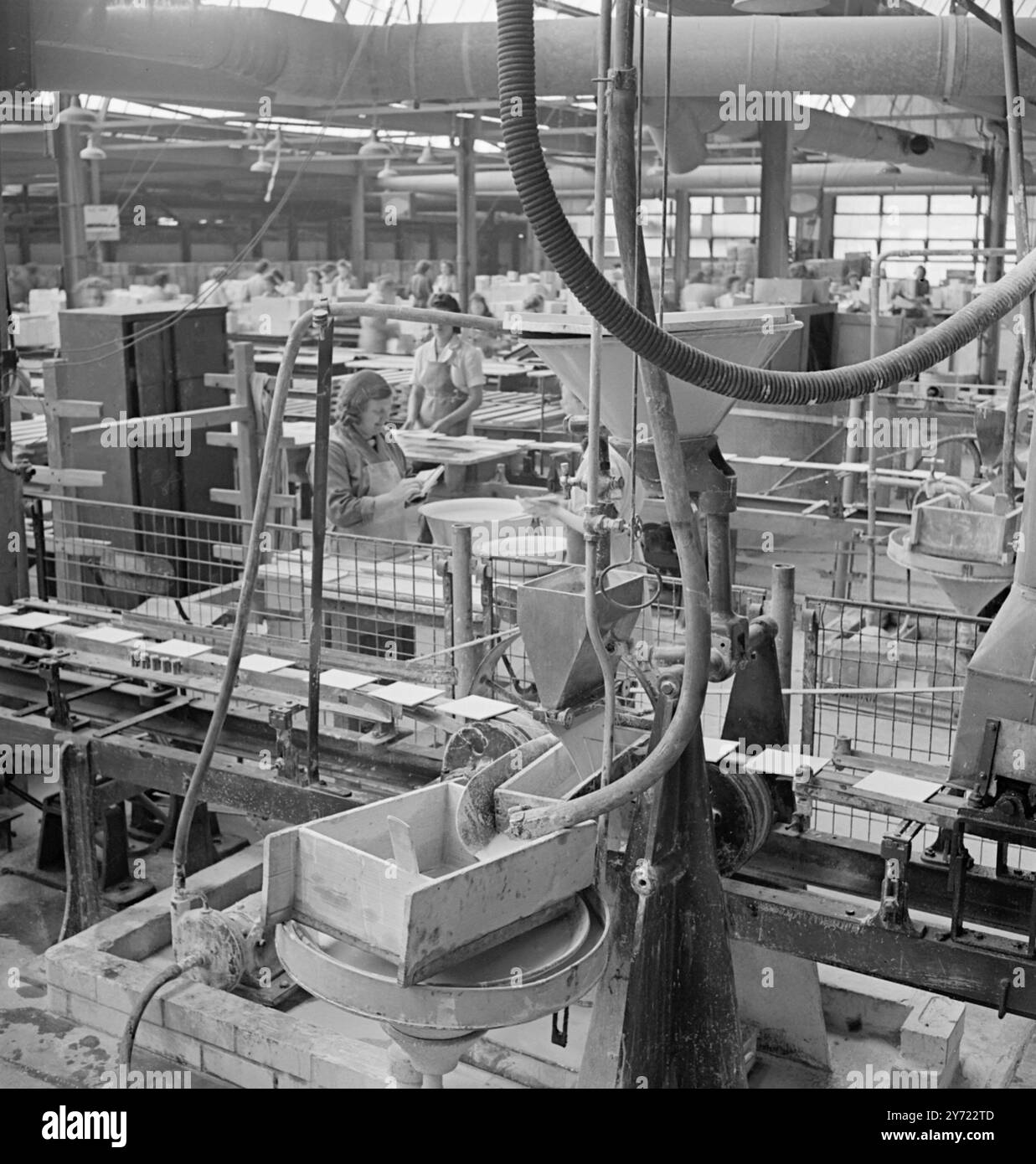 « Des siècles d'artisanat » les potiers britanniques travaillent pour Export. - - - - Convoquées par le président de la Chambre de commerce pour obtenir une augmentation de 15 % de la production dans la bataille de 1948 pour les marchés d'exportation, les poteries du pays fonctionnent comme jamais auparavant. À partir de la poussière et de la fumée des fours et des fours des «cinq villes» du nord du Staffordshire, les travailleurs, dont les compétences ont été transmises de père en fils, produisent les belles céramiques de renommée mondiale. Les machines et les méthodes modernes, cependant, vont de pair avec la tradition chez les hommes et les femmes des banques de pots. Au célèbre Josiah Banque D'Images