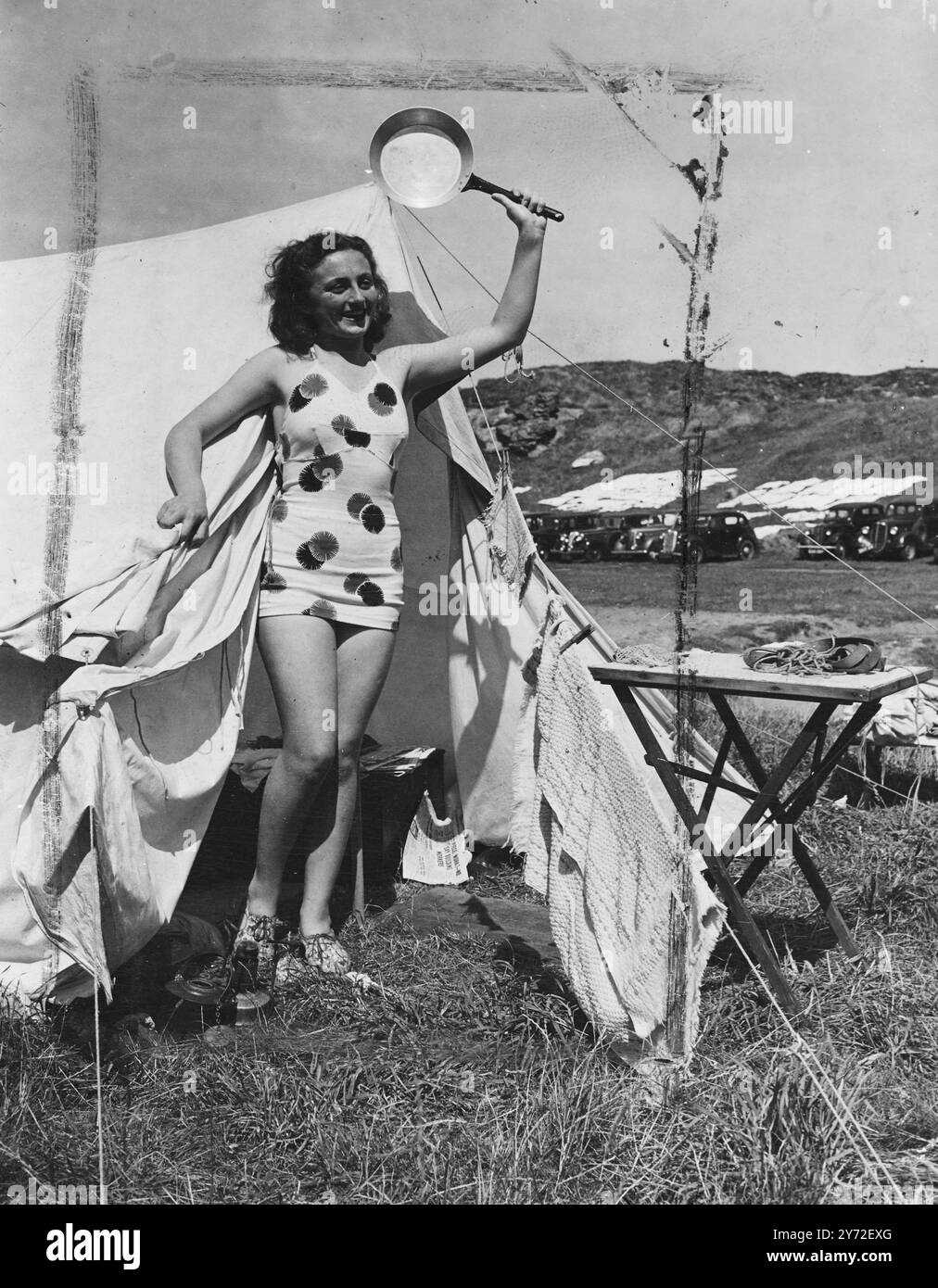 Elle est allée à l'Ouest. Mlle Jeannette Pember, de Leak, Staffordshire, caractérise l'esprit de vacances de plusieurs milliers de personnes qui ont décidé de passer des vacances de camping dans le West Country en août. Avec la côte de Cornouailles non loin, il serait difficile de trouver un meilleur endroit, et à en juger par cette photo, il devrait y avoir une précipitation pour répondre au cri de Jeannette 'Come and Get It'. 8 août 1947 Banque D'Images