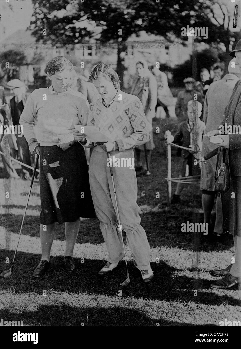 Il y a environ 50 ans, le dernier championnat de golf féminin a eu lieu à Gullane, en Écosse. Ensuite, la mode était les jupes longueur cheville, les manches mutton-top et dans certains cas principalement des voiles. Hier, la tenue était plus moderne et le soleil d'été a fait ressortir quelques couleurs plus vives. Mme Mildred Zaharias , ancienne 'Babe' Dridrikson de renommée olympique, portait des pantalons bleu clair pour son match avec Miss Helen Nimmo, de Gullane, et s'est avérée un défi redoutable pour le titre remportant le premier tour par six et cinq. Images : Mme Zaharis (à droite), photographiée sur le parcours avec son adversaire Miss Helen Banque D'Images