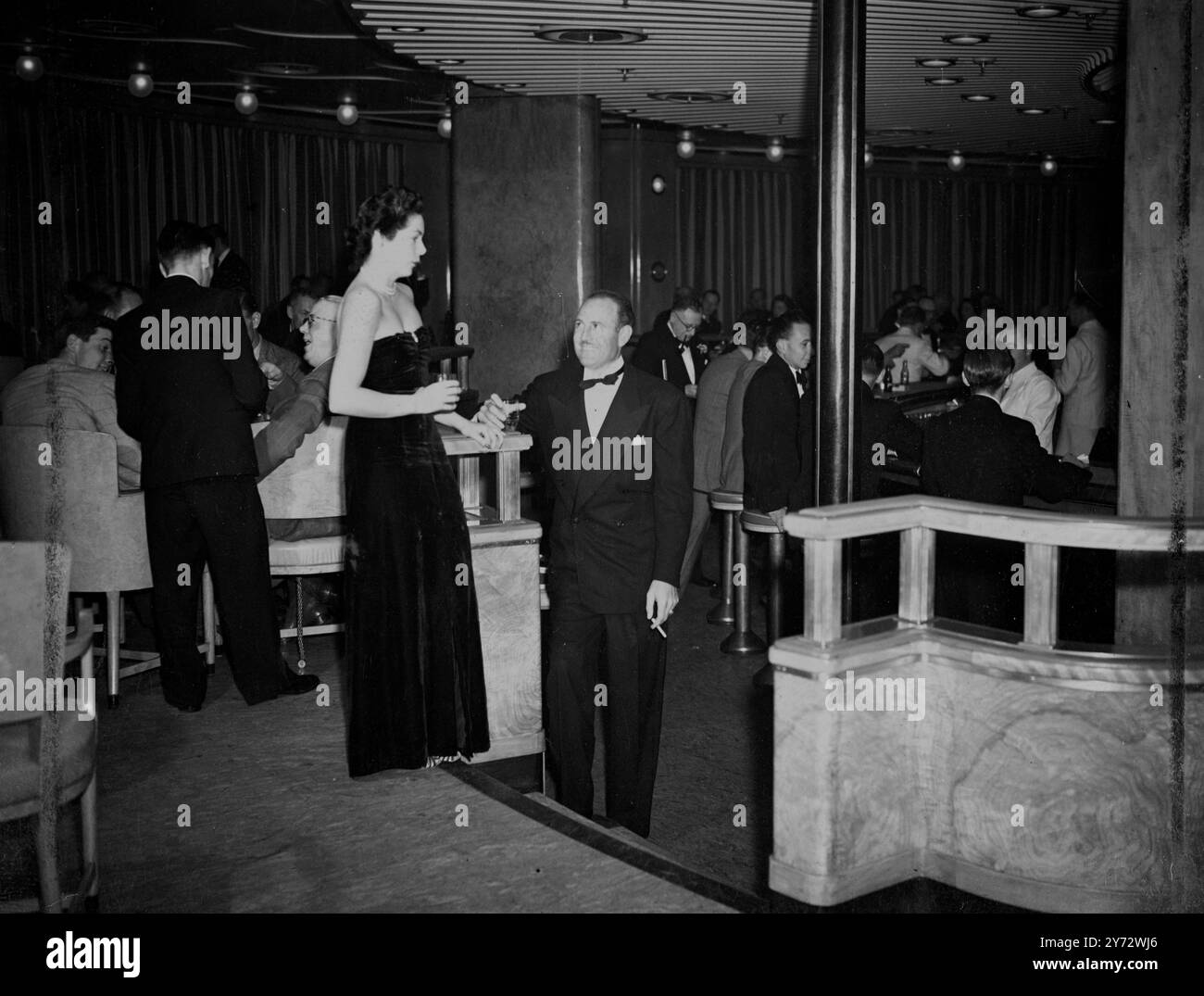 Passagers du voyage inaugural du RMS « Queen Elizabeth », un paquebot de luxe, dans le bar du bateau en dégustant quelques boissons. 23 octobre 1946 Banque D'Images