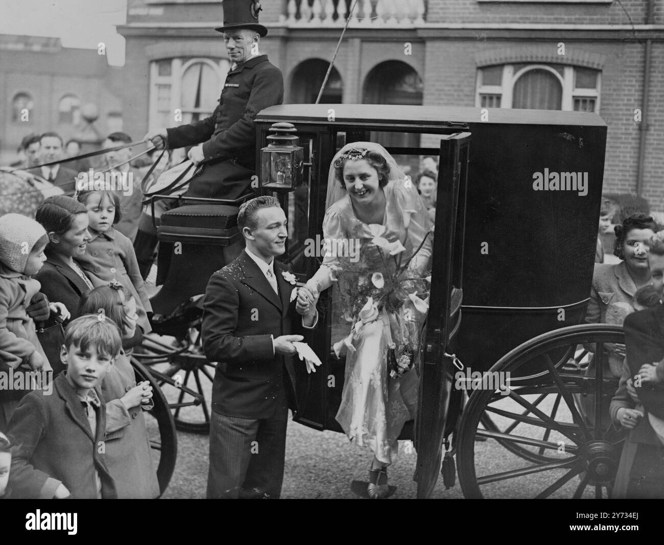 Après leur mariage à l'église St Matthews, Wandsworth Bridge Road, l'époux Stanley George Prusher a aidé son épouse Miss Betty Watson à descendre d'une voiture conduite par deux chevaux gris avec des coachs avec des livreurs, à leur arrivée à leur réception. 6 avril 1946 Banque D'Images Après leur mariage à l'église St Matthews, Wandsworth Bridge Road, l'époux Stanley George Prusher a aidé son épouse Miss Betty Watson à descendre d'une voiture conduite par deux chevaux gris avec des coachs avec des livreurs, à leur arrivée à leur réception. 6 avril 1946 Banque D'Images