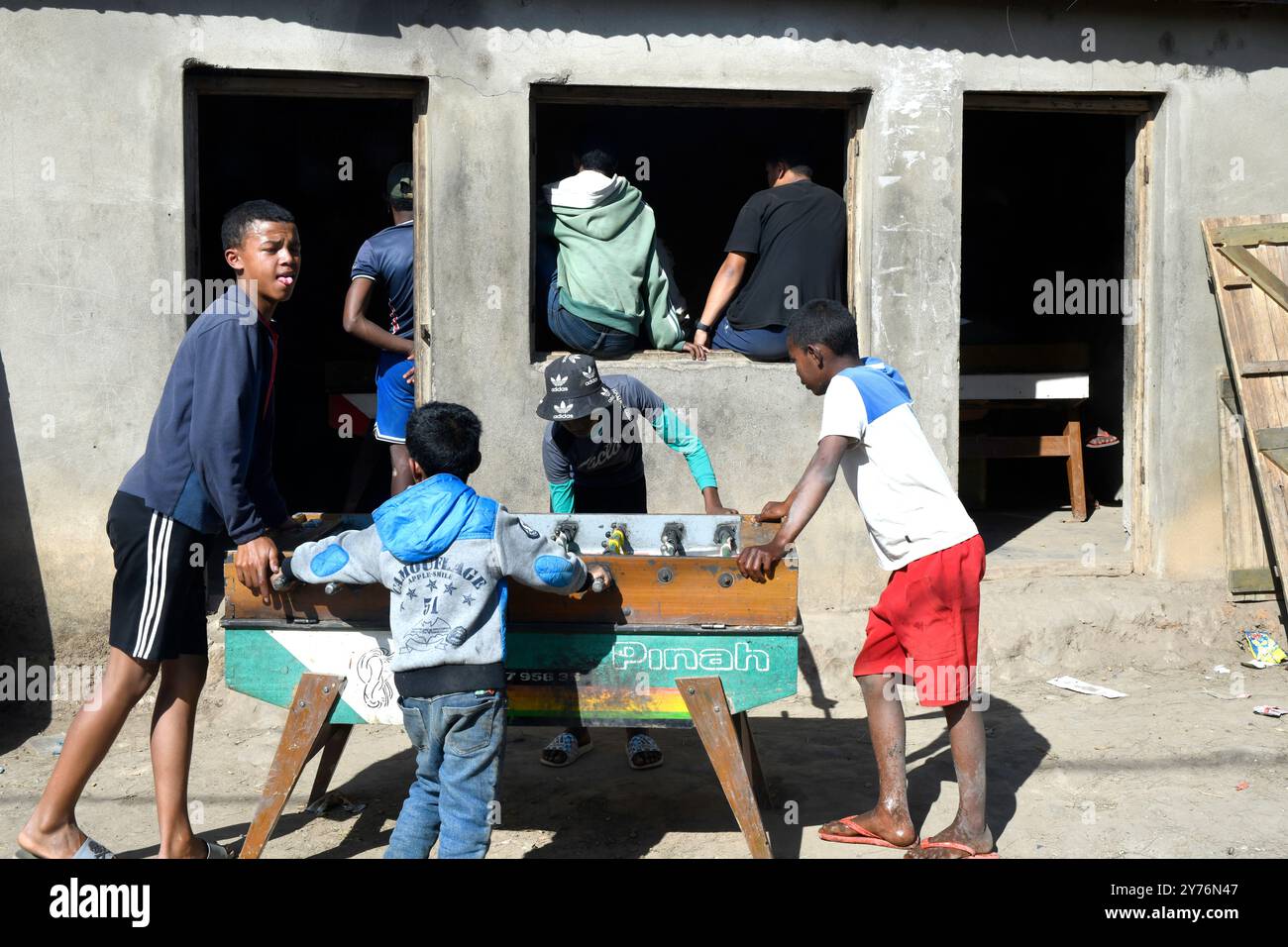 Ambatolampy, enfants jouant au baby-foot. Hauts plateaux centraux, région de Vakinankaratra, Madagascar. Banque D'Images