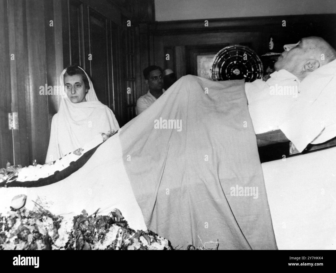 28 MAI 1964 décédé et fille. La fille de Nehru, Mme India Gandhi (à gauche), se tient grièvement près du corps de son père décédé, Pandhi Nehru, qui est resté en état pendant 18 heures ici aujourd'hui. Le premier ministre indien, décédé hier, a été incinéré aujourd'hui sur les rives du fleuve. Jumna. Son petit-fils de 18 ans a poussé une torche dans le salon funéraire et des flammes ont englouti le corps. New Dehli, Inde Banque D'Images