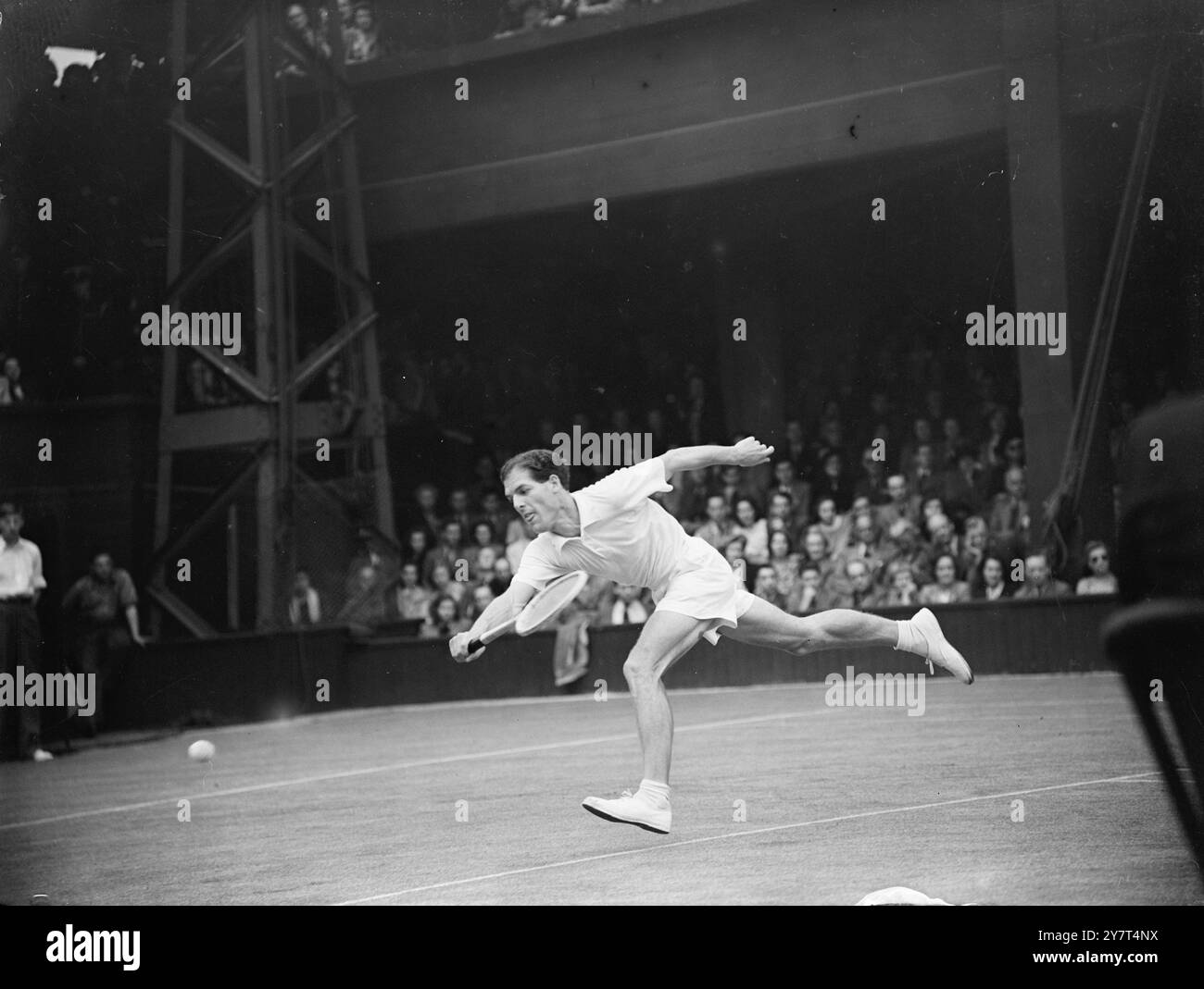 MOTTRAM SE LANCE CONTRE DROBNY Mighty Stride de TONY MOTTRAM , le N°1 britannique, alors qu'il affrontait Jaroslav Drobny de Tchécoslovaquie au deuxième tour ( zone européenne ) de la compétition de Coupe Davis entre la Grande-Bretagne et la Tchécoslovaquie , à Wimbledon ( Londres ) . 14 mai 1949 Banque D'Images