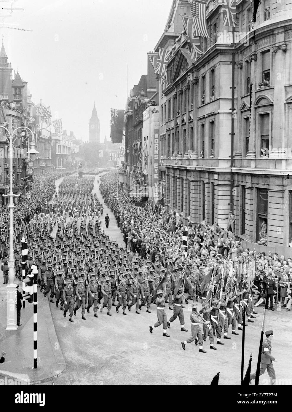 LES VAINQUEURS DE LA GUERRE DÉFILENT À TRAVERS LONDRES ALORS QUE DES MILLIONS de personnes ACCLAMENT la route, une colonne de marche de 21000 soldats de tout l'Empire britannique et des pays alliés et une colonne mécanisée de 480 véhicules allant des jeeps aux engins de combat blindés les plus lourds traversaient les rues de londres pour célébrer le jour de la victoire. - Des commandants célèbres ont conduit dans le cortège, et des contingents spéciaux ont représenté les travailleurs et les défenseurs du Front intérieur. Le roi George VI , qui était accompagné d'autres membres de la famille royale, a pris le salut dans le Mall. - Photo Sho Banque D'Images