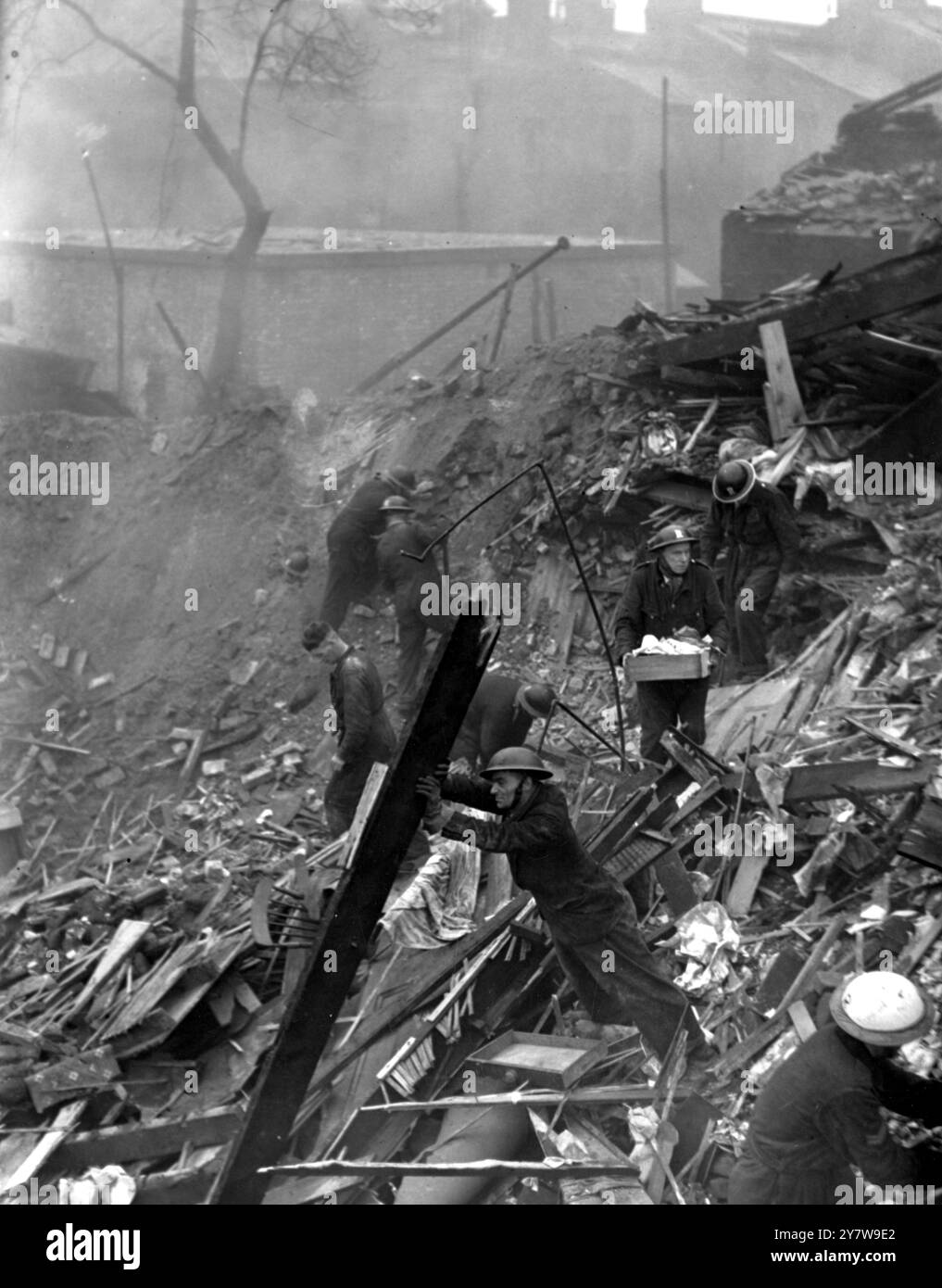 Des maisons ont été endommagées lors de raids nocturnes sur la région de Londres lorsque des bombes ont été larguées par des raids allemands. Photo montre : des membres du groupe de sauvetage fouillant parmi les débris à Walworth Road. 9 décembre 1940 photographie de Thérèse Bonney Planet News Banque D'Images