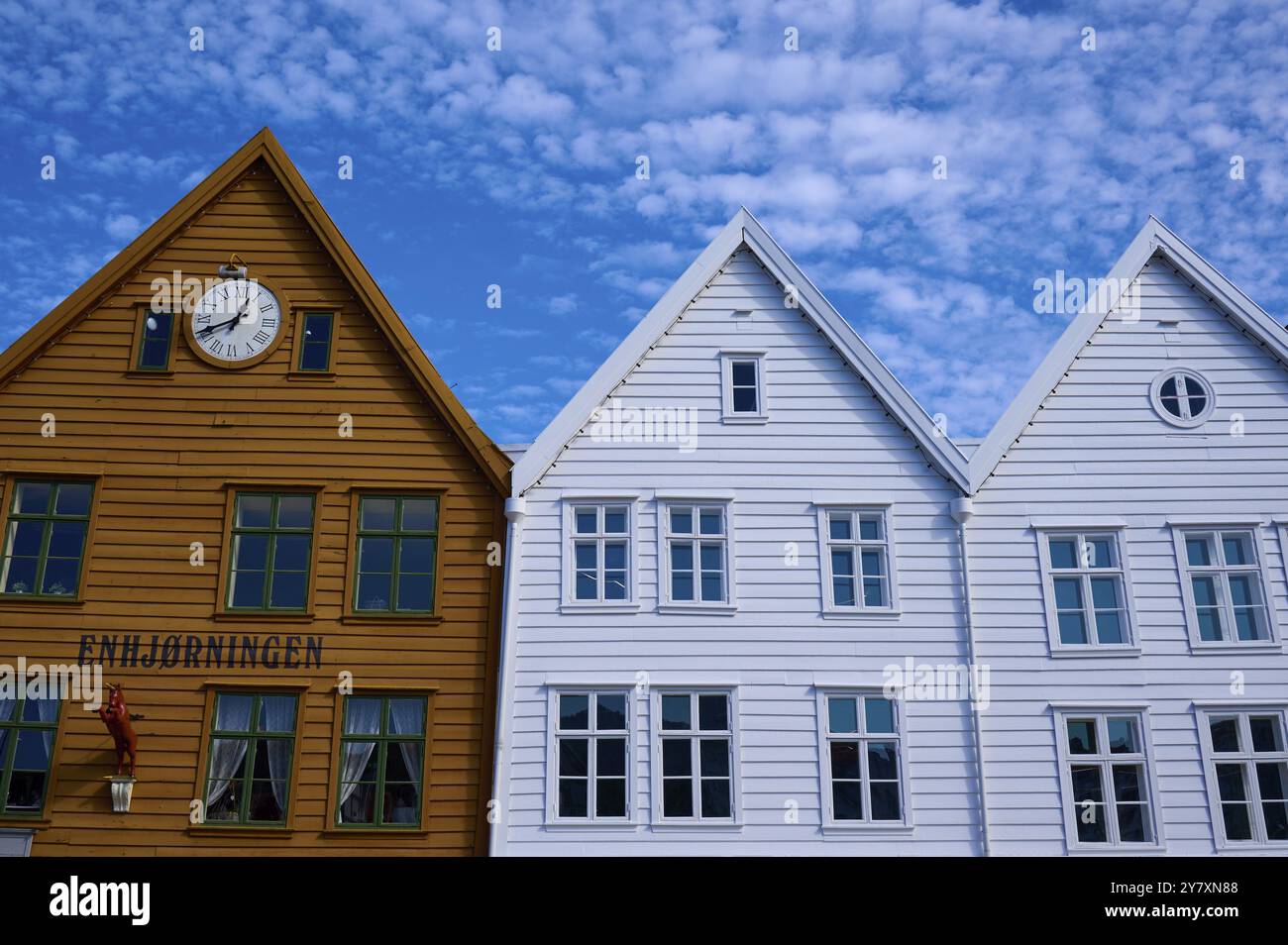 Maisons traditionnelles en bois sous un ciel bleu avec des toits inclinés et de multiples fenêtres dans une vieille ville ensoleillée, Bryggen, Bergen, Vestland, Norvège, Europe Banque D'Images