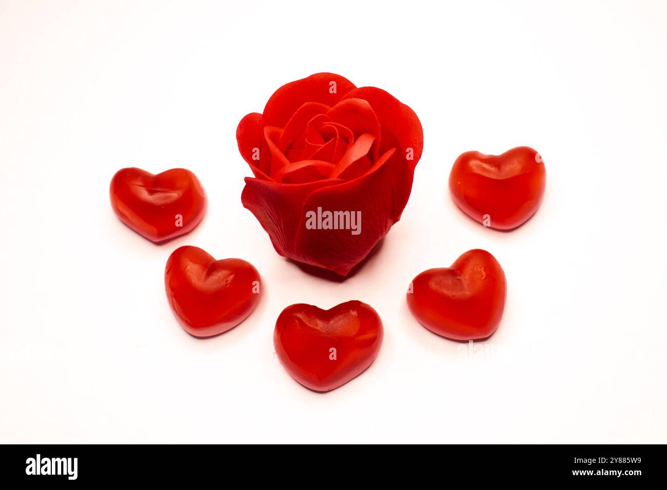 Rose rouge isolée et coeurs de gelée rouge sur fond blanc, papier peint de Saint-Valentin, conception de carte d'amour, carte d'anniversaire Banque D'Images