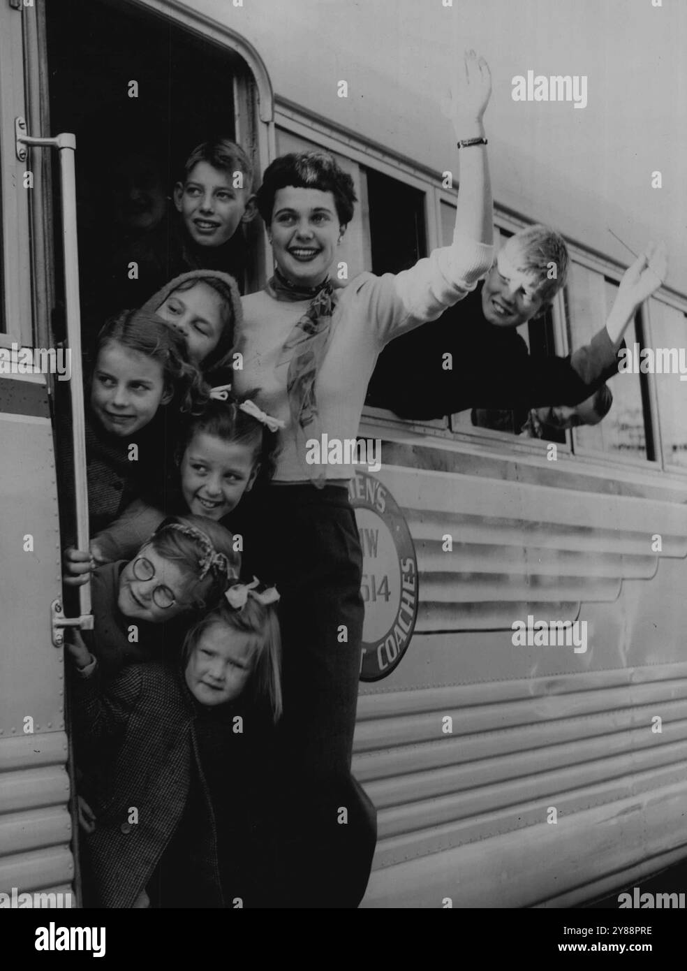 Jubilee Trip pour les migrants -- N'avons-nous pas de chance : les enfants migrants britanniques aux grands yeux de l'auberge de Brooklyn font un adieu joyeux alors qu'ils partent pour un trajet en bus le jour du Jubilé jusqu'à Sassafras. Le voyage a été organisé par la jeune Chambre de commerce pour 71 enfants et 10 adultes. Le guide, avec les enfants, est Miss Betty Constable - son grand souci était le temps. 14 mai 1951. Banque D'Images