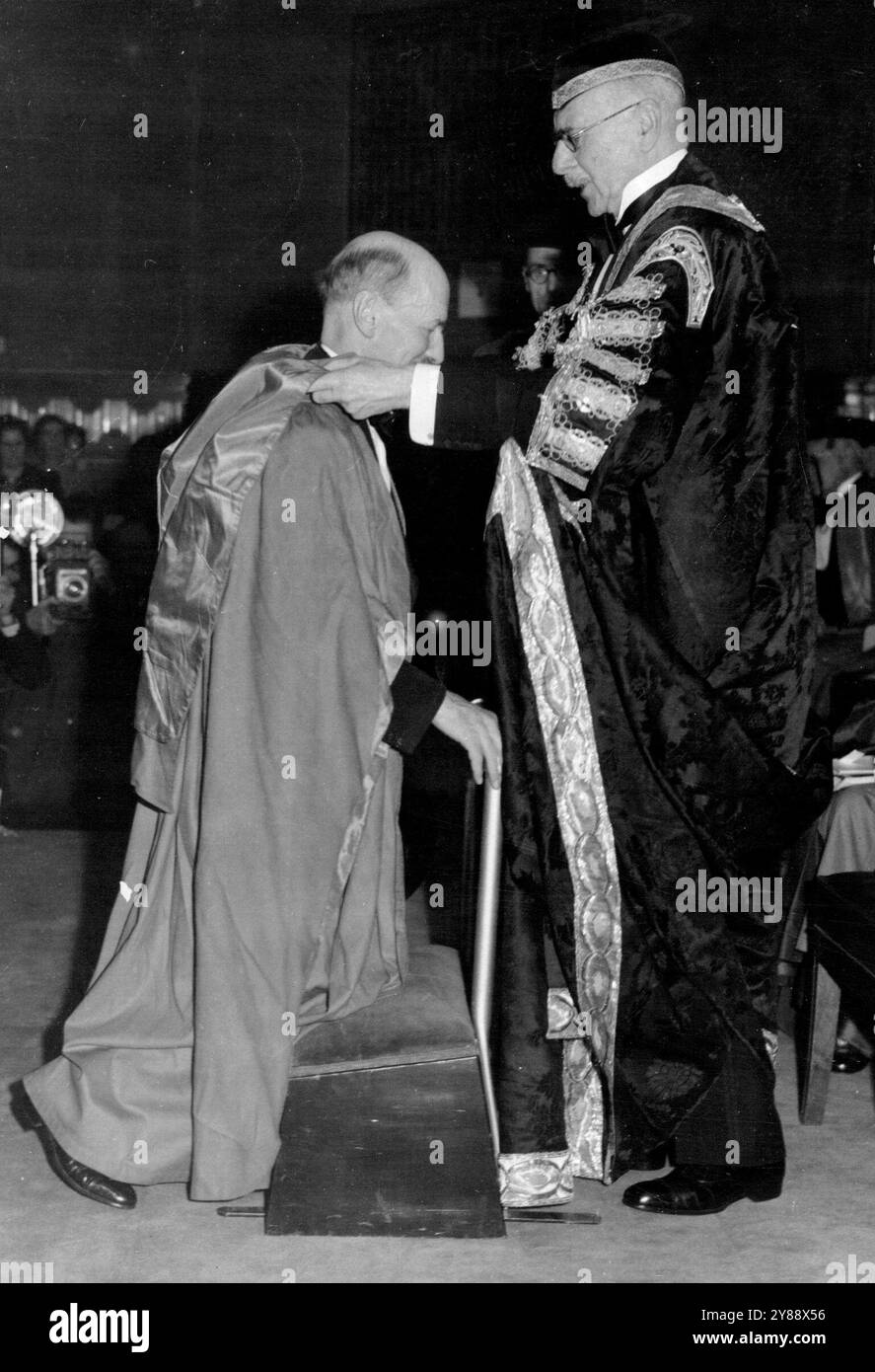 Le premier ministre reçoit un diplôme honorifique à l'Université de Londres -- M. Clement Attlee s'agenouille pour recevoir le diplôme du chancelier, le comte d'Athlene, à l'Université de Londres. Le premier ministre britannique, M. Clement Attlee, a reçu le diplôme honorifique de docteur en droit des mains du chancelier, le comte d'Athlene, à l'occasion de la célébration de la Journée de la Fondation à l'Université de Londres. La cérémonie de conférence a eu lieu dans les bâtiments de l'Université à Bloomsbury, Londres. 28 novembre 1947. Banque D'Images