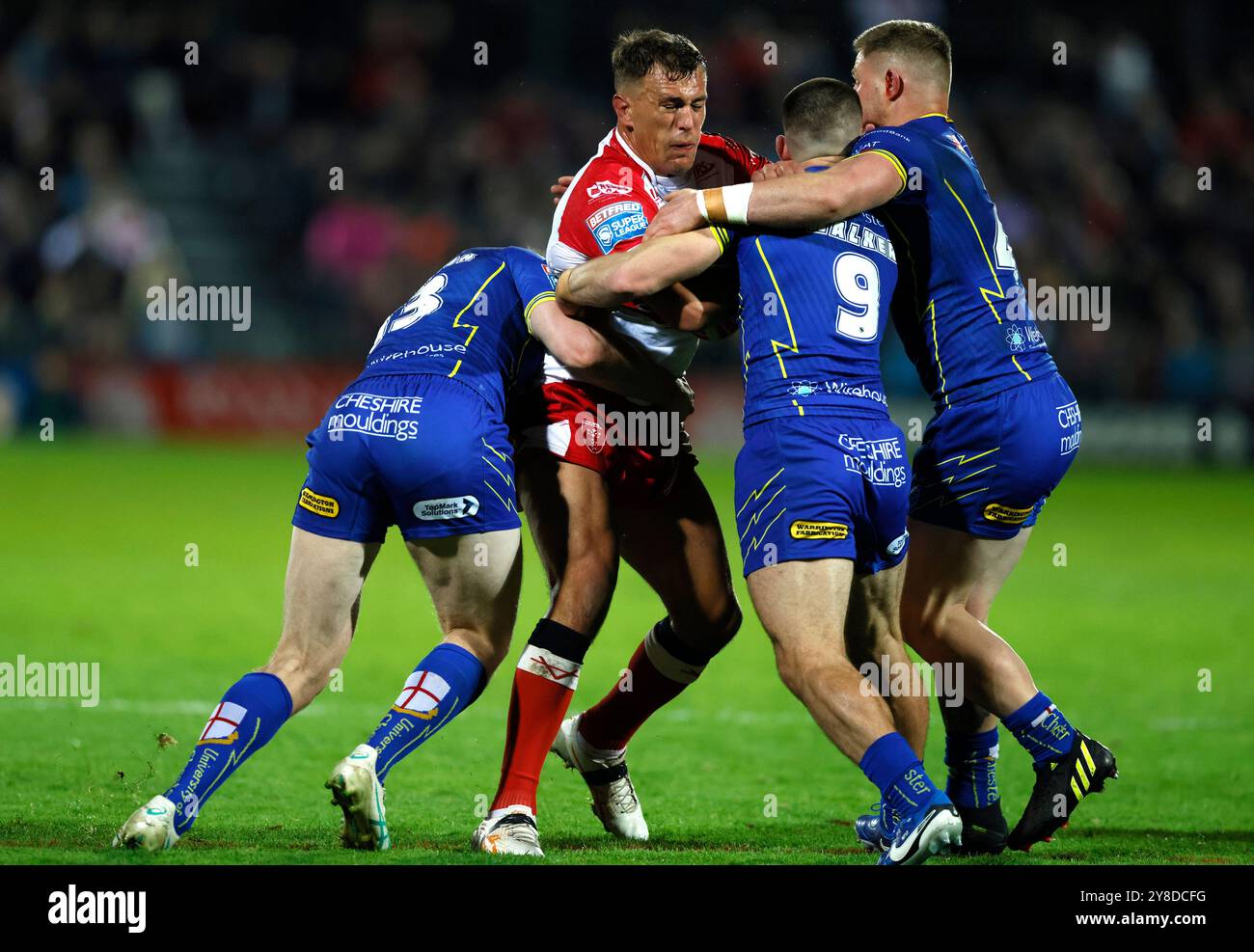 Jai Whitbread de Hull KR (au centre) est attaqué par Matty Nicholson de Warrington Wolves (à gauche), Danny Walker et Luke Yates lors de la demi-finale de Betfred Super League, match de play-off à Craven Park, Hull. Date de la photo : vendredi 4 octobre 2024. Banque D'Images