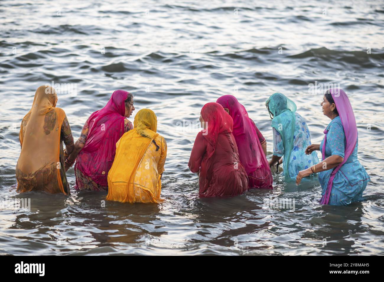 Pèlerins hindous, femme en saris colorés, prendre un bain sacré dans la mer devant le lever du soleil à Ghat Agni Theertham, Rameswaram ou Rameshwaram, île de Pamban Banque D'Images