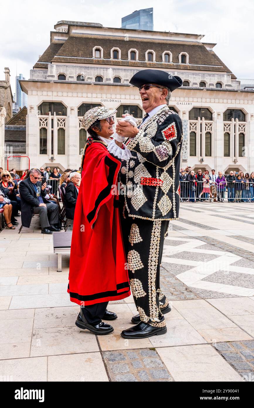 A Pearly King change de chapeaux et de danses avec Un maire de London Borough au festival annuel de récolte des Pearly Kings et Queens Costermongers, Londres, Royaume-Uni. Banque D'Images A Pearly King change de chapeaux et de danses avec Un maire de London Borough au festival annuel de récolte des Pearly Kings et Queens Costermongers, Londres, Royaume-Uni. Banque D'Images