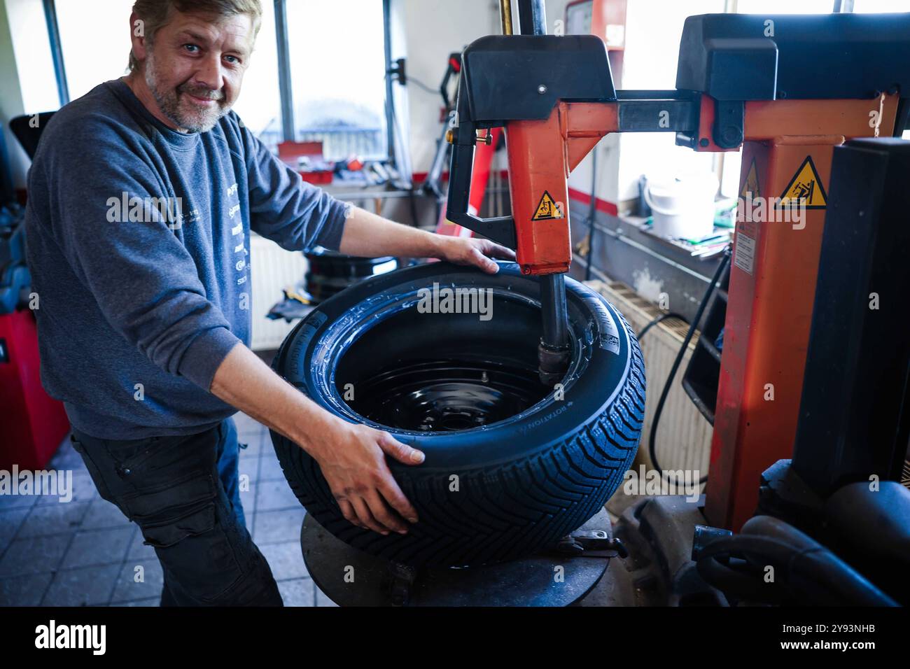 07.10.2024, Geretsberg, AUT, Unterwegs in Innviertel, Symbolbild, Themenbild, Verschiedene Themenbilder, Reifen Wechsel, im Bild Ein Mechaniker montiert Winterreifen an einem Auto in einer KFZ-Werkstatt. AM 1. Novembre débutant à Österreich für Pkw und LKW bis 3,5 Tonnen die situative Winterausrüstungspflicht. // Un mécanicien automobile monte des pneus hiver sur une voiture dans un garage. Le 1er novembre, l'obligation d'équipement hivernal de situation commence en Autriche pour les voitures particulières et les camions jusqu'à 3,5 tonnes, Autriche, Reifen, Montieren, montage, Wuchten, *** 07 10 2024, Geretsberg, AUT, Unterwegs in Innviertel, S Banque D'Images